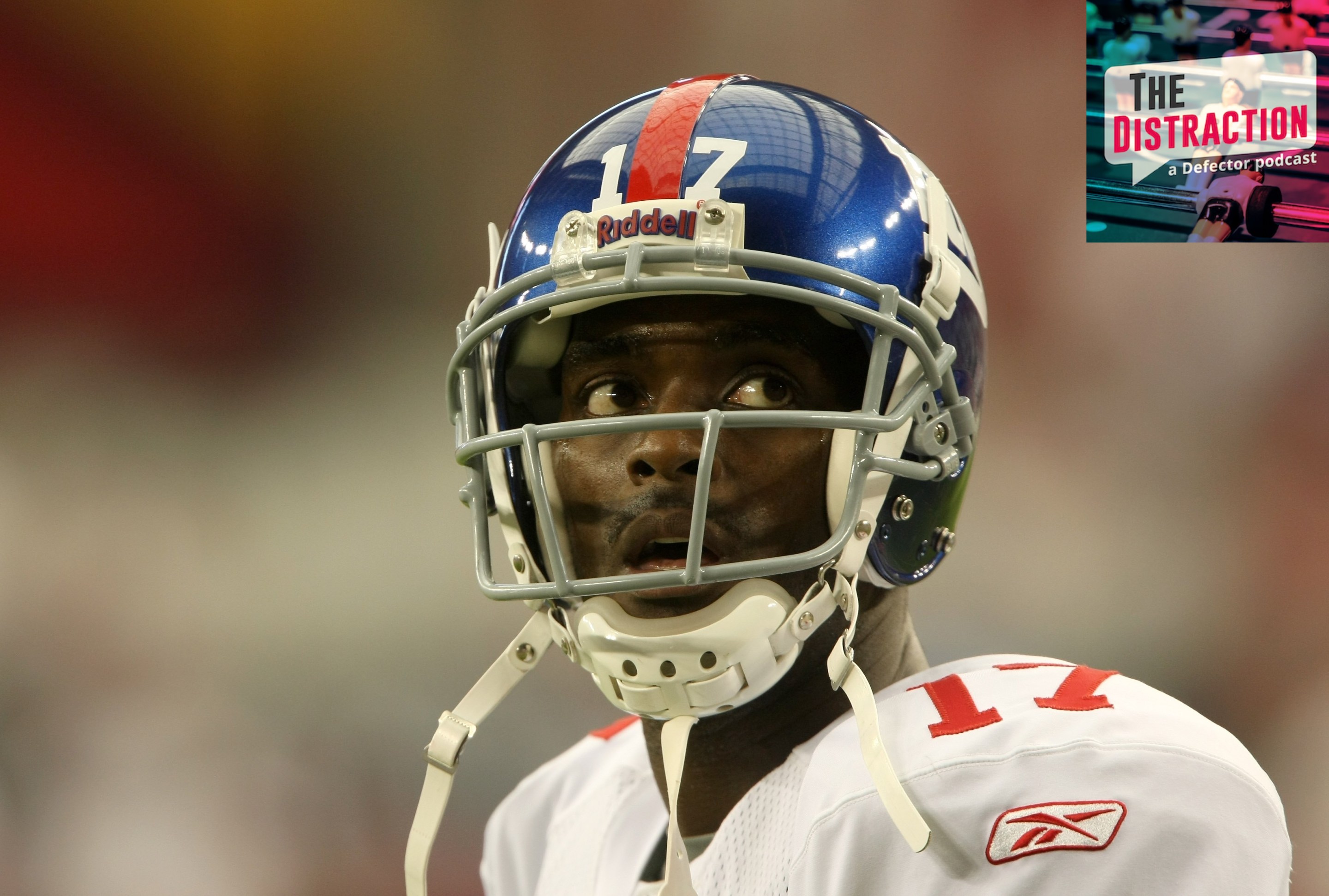 Wide receiver Plaxico Burress #17 of the New York Giants warms up for the game with the Arizona Cardinals on November 23, 2008. It looks like he's looking at the Distraction logo at upper right of the frame.