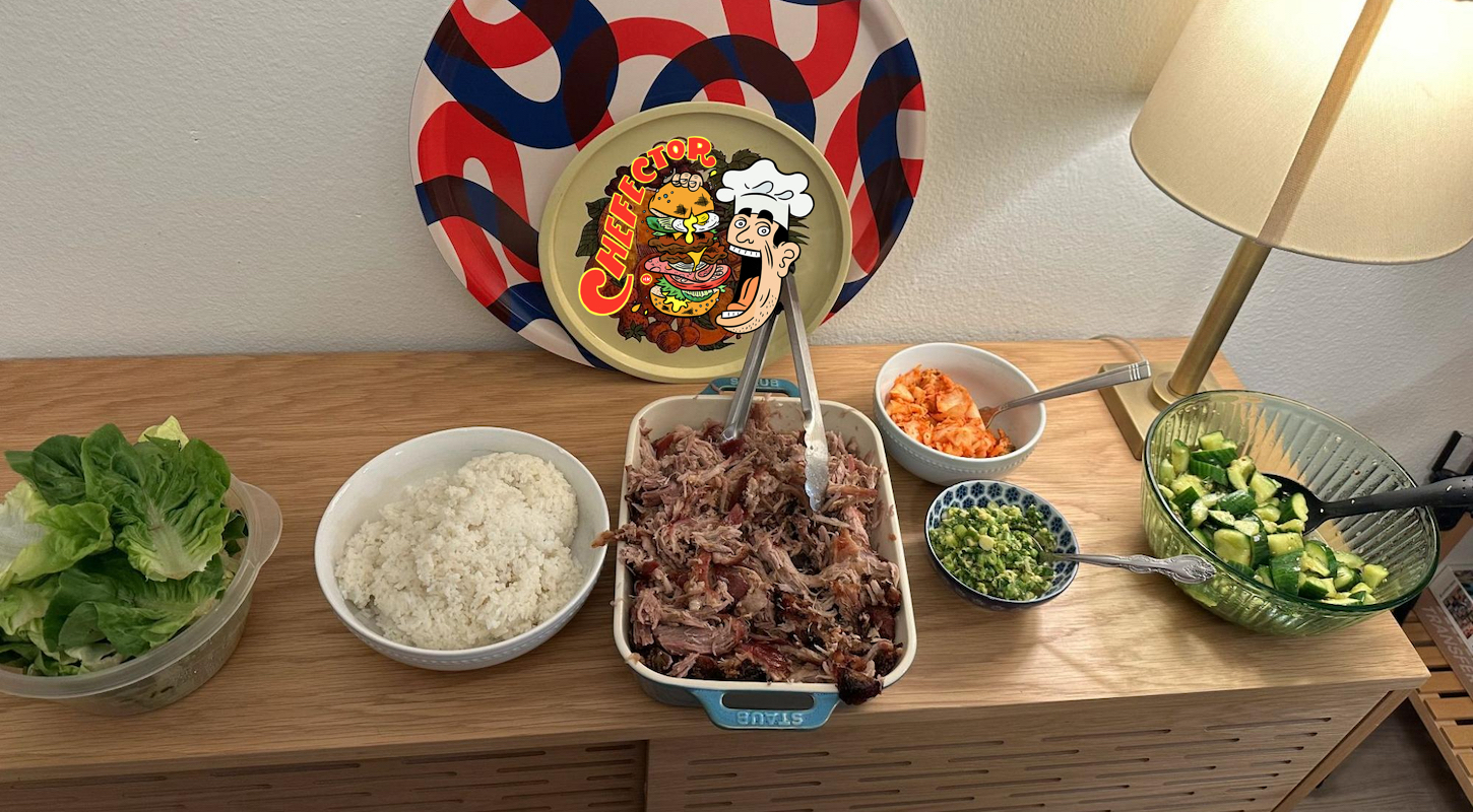 A sideboard-type piece of furniture with a spread of food including pork, rice, lettuce, cucumber salad, and kimchi, plus a pair of decorative plates and a lamp. Plus the Chefector logo.