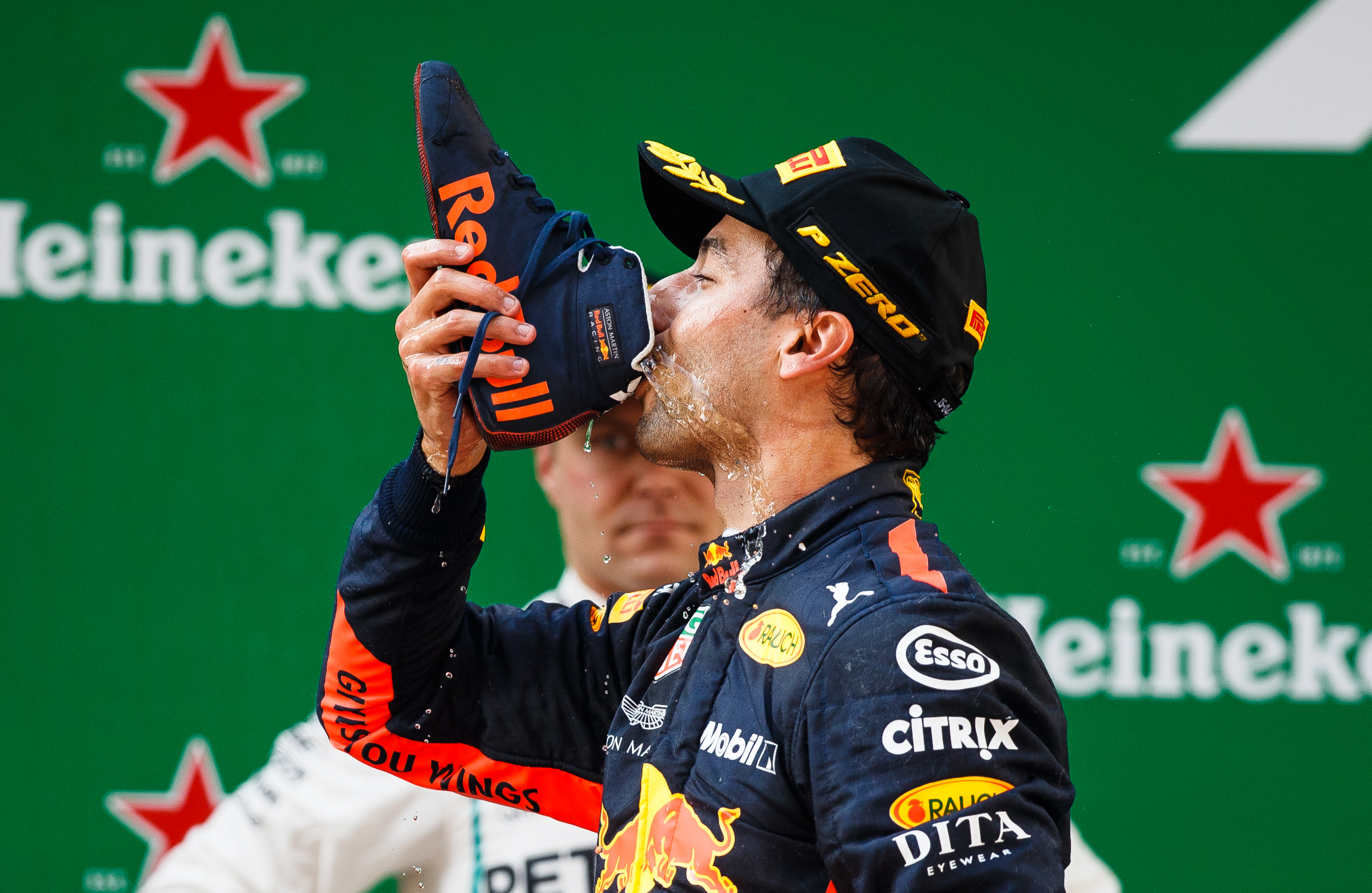 Race winner Daniel Ricciardo of Australia and Red Bull Racing celebrates on the podium with a shoey.