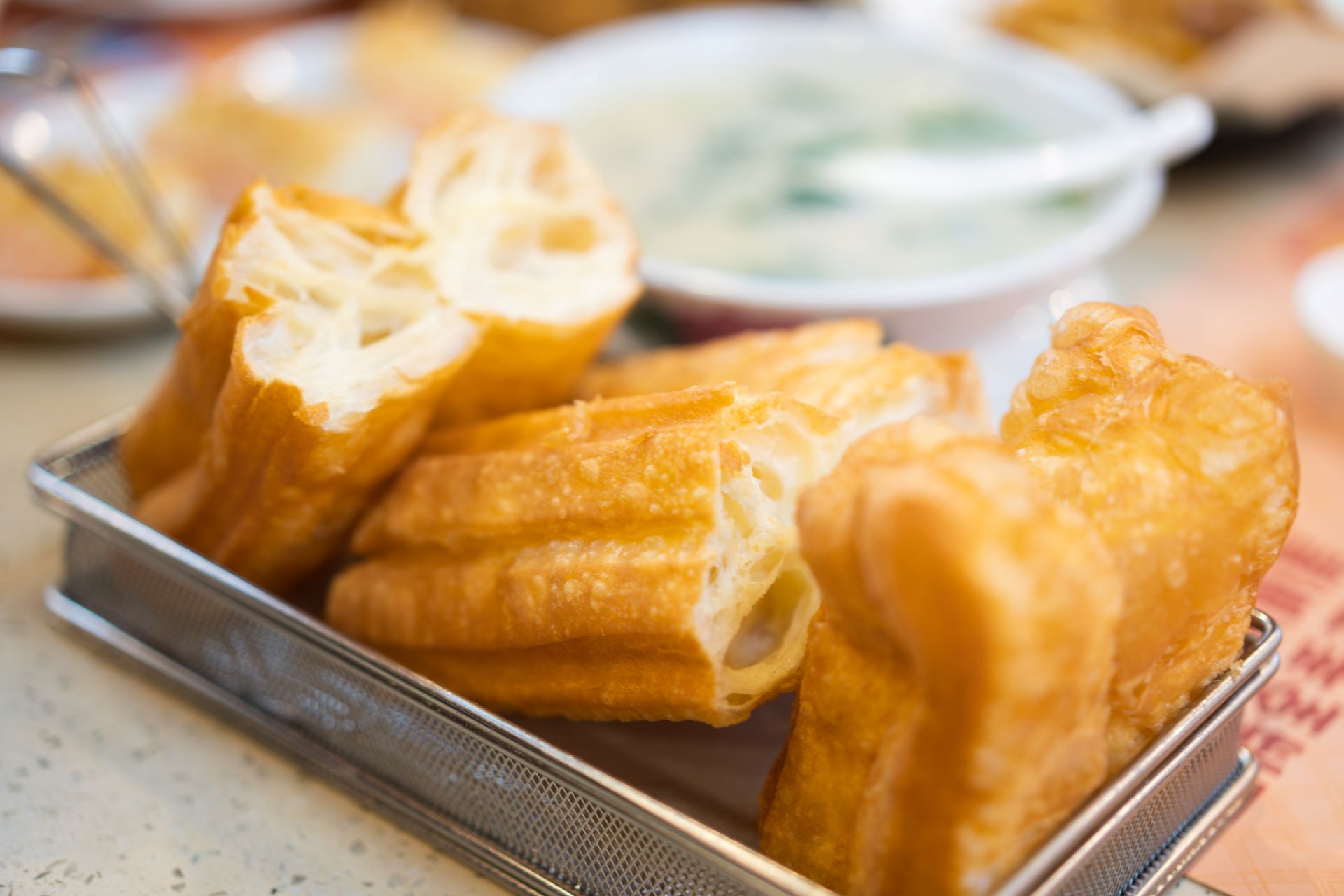 A picture of youtiao, or fried dough sticks, in a tray.