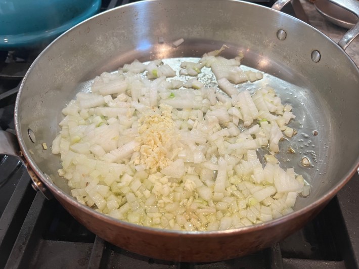 Onions and garlic in a sauté pan.