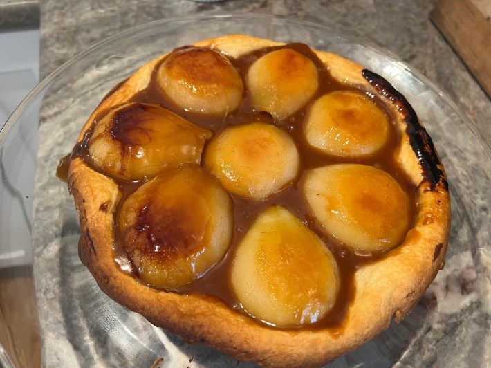 A look down at a finished tarte tatin, showing some burned caramel along one edge.