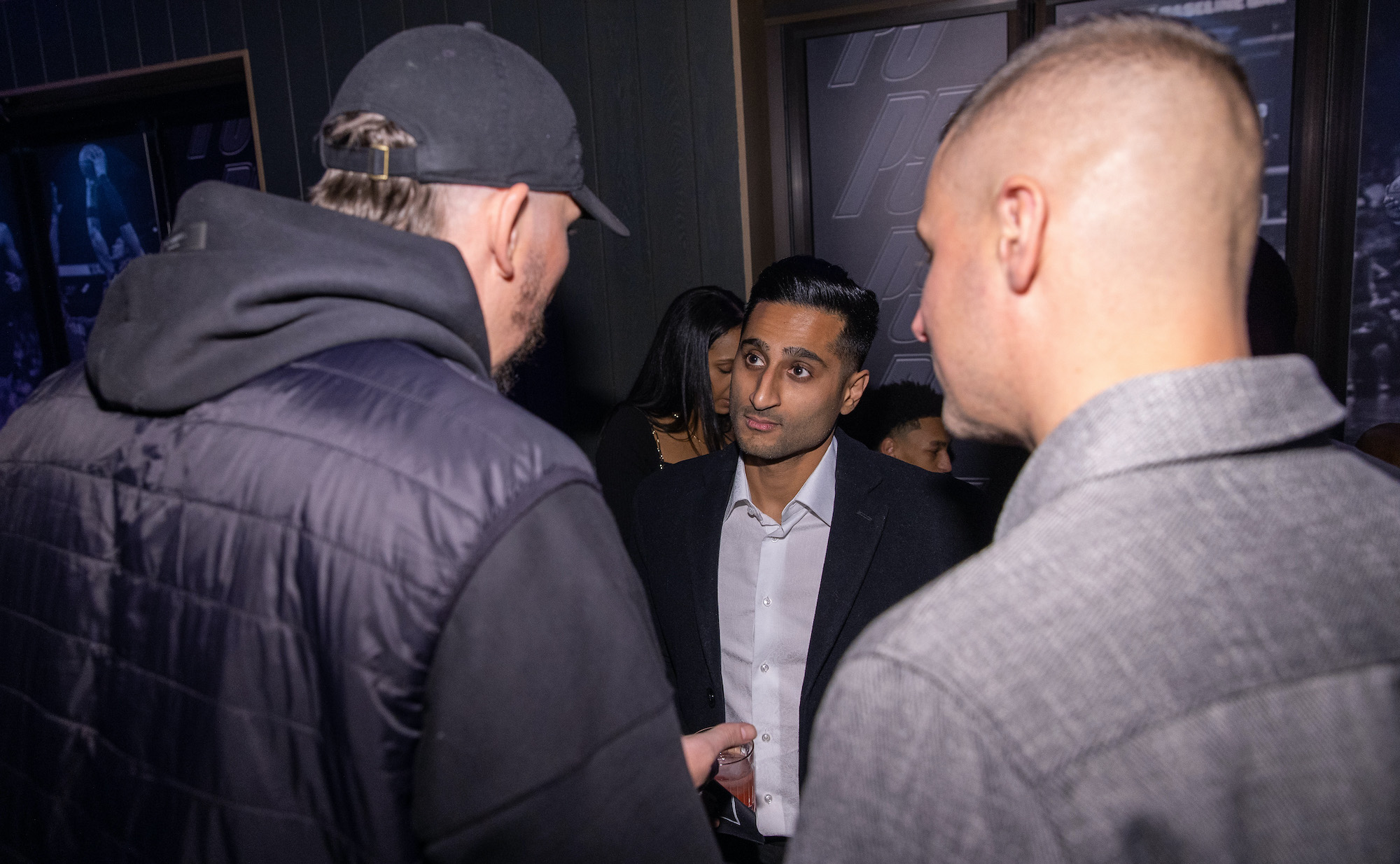 Shams Charania speaks with Mike Miller (L) and Donnie McGrath during the Paolo Banchero All Star Weekend kickoff party