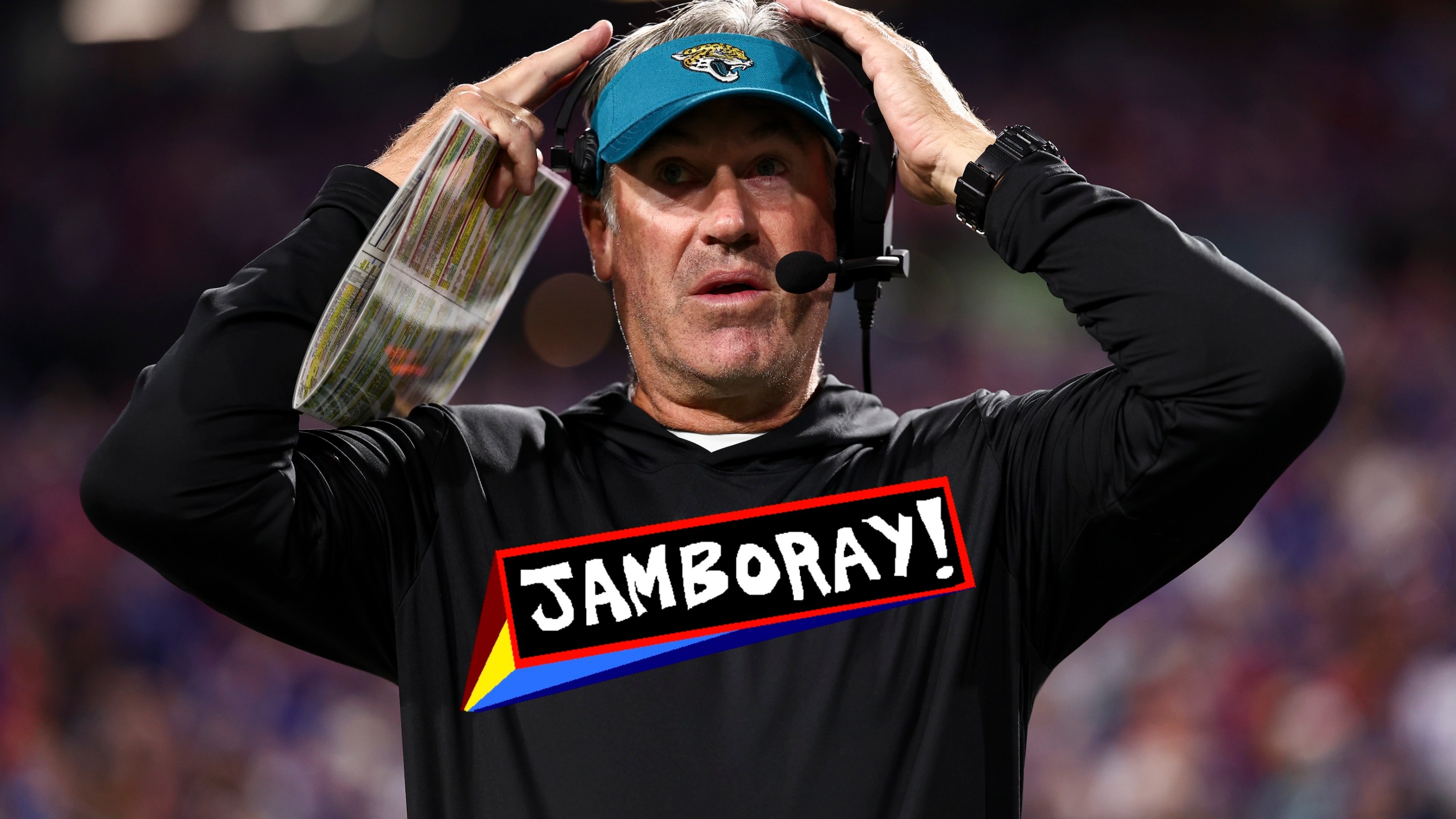 Head coach Doug Pederson of the Jacksonville Jaguars adjusts his headset prior to an NFL football game against the Buffalo Bills. He looks pretty goofy, and the JAMBORAY badge is imposed over the Jags logo on his shirt.