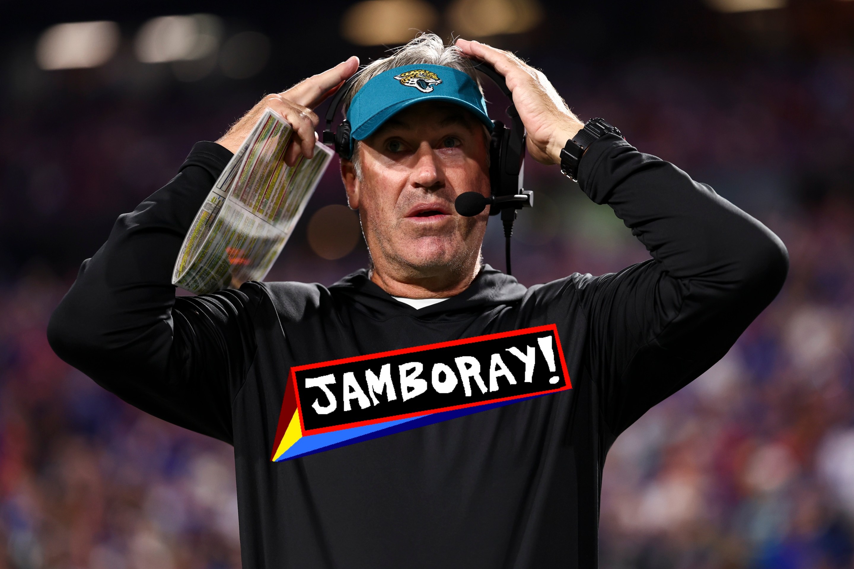 Head coach Doug Pederson of the Jacksonville Jaguars adjusts his headset prior to an NFL football game against the Buffalo Bills. He looks pretty goofy, and the JAMBORAY badge is imposed over the Jags logo on his shirt.