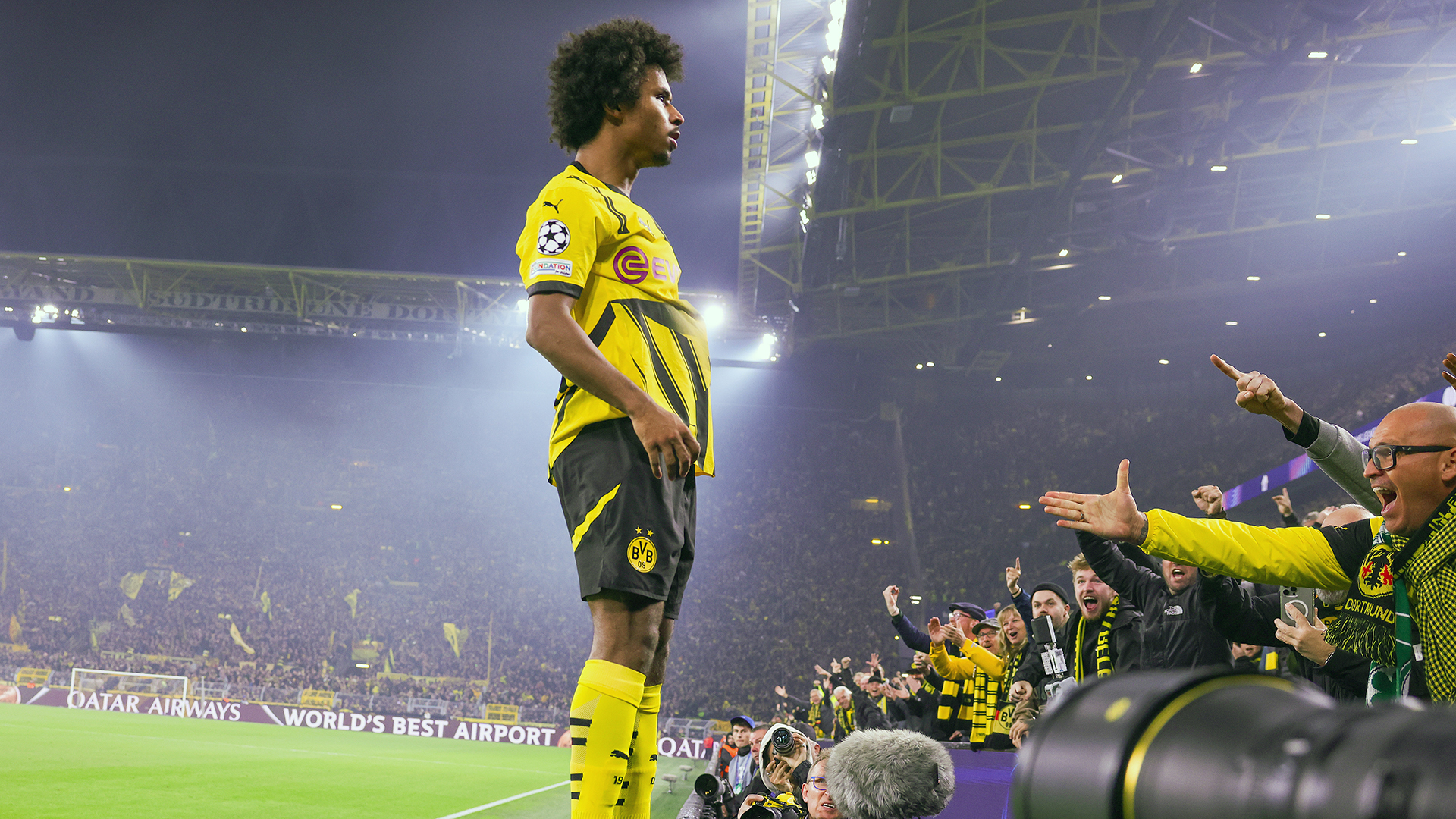 Karim Adeyemi of Borussia Dortmund celebrates the teams second on advertising band during the UEFA Champions League 2024/25 League Phase MD6 match between Borussia Dortmund and Celtic FC at BVB Stadion Dortmund on October 1, 2024 in Dortmund, Germany.