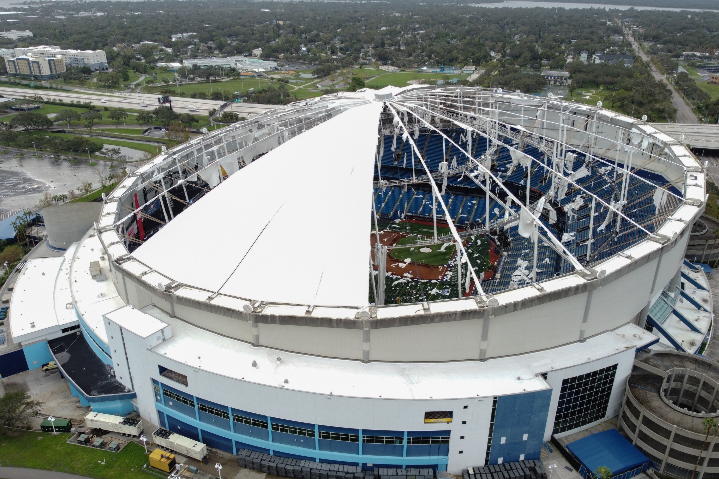 A drone image shows the dome of Tropicana Field which has been torn open due to Hurricane Milton in St. Petersburg, Florida, on October 10, 2024. At least four people were confirmed killed as a result of two tornadoes triggered by Hurricane Milton on the east coast of the US state of Florida, local authorities said Thursday. (Photo by Bryan R. SMITH / AFP)