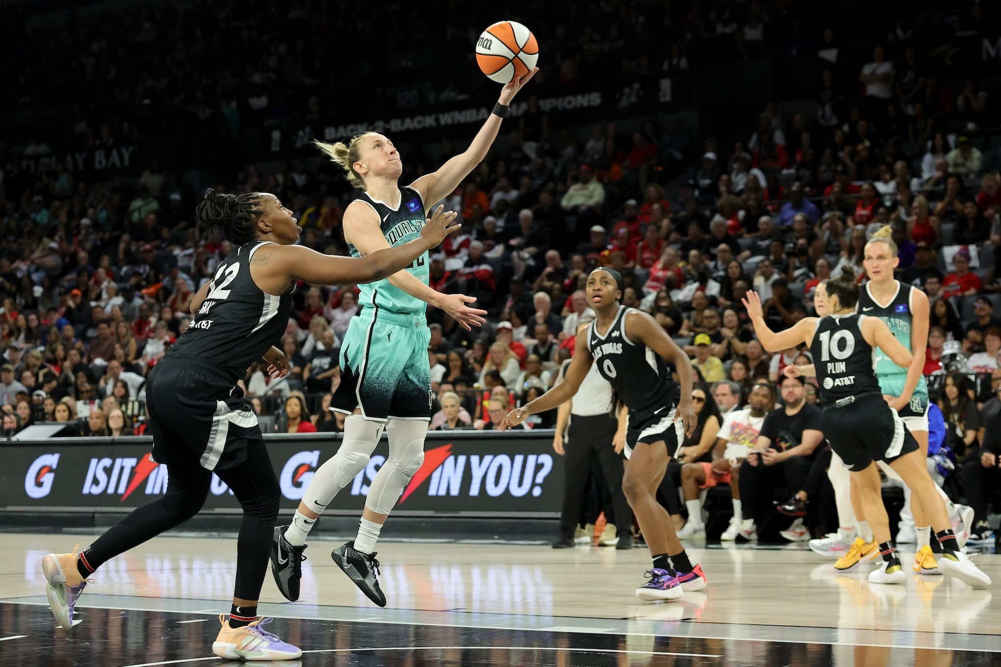 LAS VEGAS, NEVADA - OCTOBER 06: Courtney Vandersloot #22 of the New York Liberty shoots a layup against Chelsea Gray #12 of the Las Vegas Aces in the fourth quarter of Game Four of the 2024 WNBA Playoffs semifinals at Michelob ULTRA Arena on October 06, 2024 in Las Vegas, Nevada. The Liberty defeated the Aces 76-62 to win the series three games to one. NOTE TO USER: User expressly acknowledges and agrees that, by downloading and or using this photograph, User is consenting to the terms and conditions of the Getty Images License Agreement. (Photo by Ethan Miller/Getty Images)