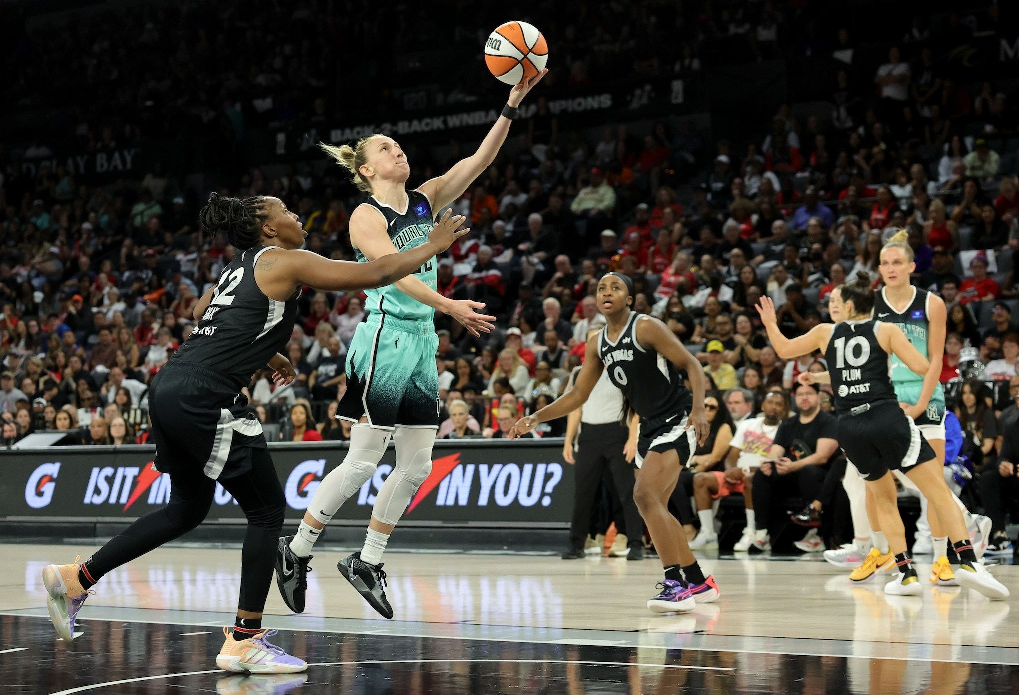 LAS VEGAS, NEVADA - OCTOBER 06: Courtney Vandersloot #22 of the New York Liberty shoots a layup against Chelsea Gray #12 of the Las Vegas Aces in the fourth quarter of Game Four of the 2024 WNBA Playoffs semifinals at Michelob ULTRA Arena on October 06, 2024 in Las Vegas, Nevada. The Liberty defeated the Aces 76-62 to win the series three games to one. NOTE TO USER: User expressly acknowledges and agrees that, by downloading and or using this photograph, User is consenting to the terms and conditions of the Getty Images License Agreement. (Photo by Ethan Miller/Getty Images)