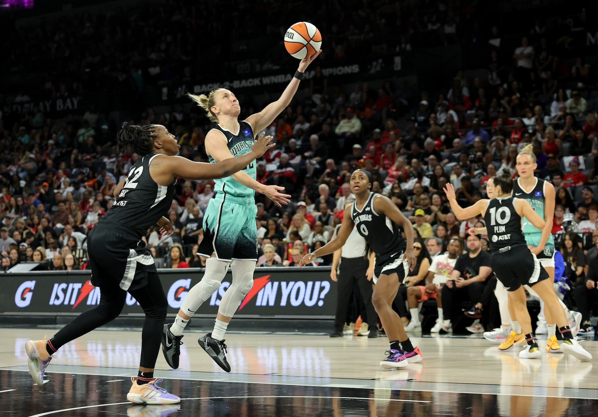 LAS VEGAS, NEVADA - OCTOBER 06: Courtney Vandersloot #22 of the New York Liberty shoots a layup against Chelsea Gray #12 of the Las Vegas Aces in the fourth quarter of Game Four of the 2024 WNBA Playoffs semifinals at Michelob ULTRA Arena on October 06, 2024 in Las Vegas, Nevada. The Liberty defeated the Aces 76-62 to win the series three games to one. NOTE TO USER: User expressly acknowledges and agrees that, by downloading and or using this photograph, User is consenting to the terms and conditions of the Getty Images License Agreement. (Photo by Ethan Miller/Getty Images)