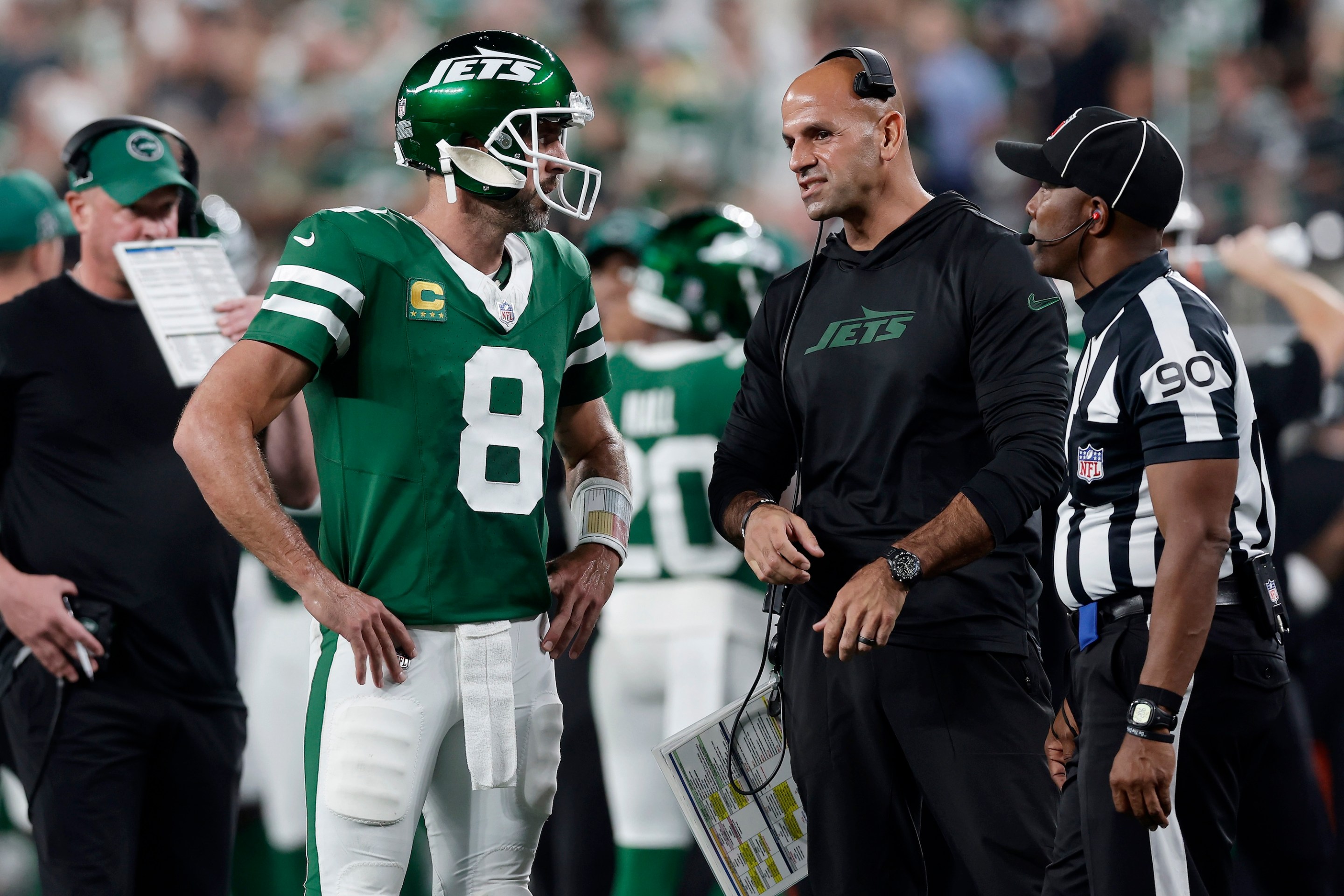 Aaron Rodgers and Robert Saleh talk on the sideline.