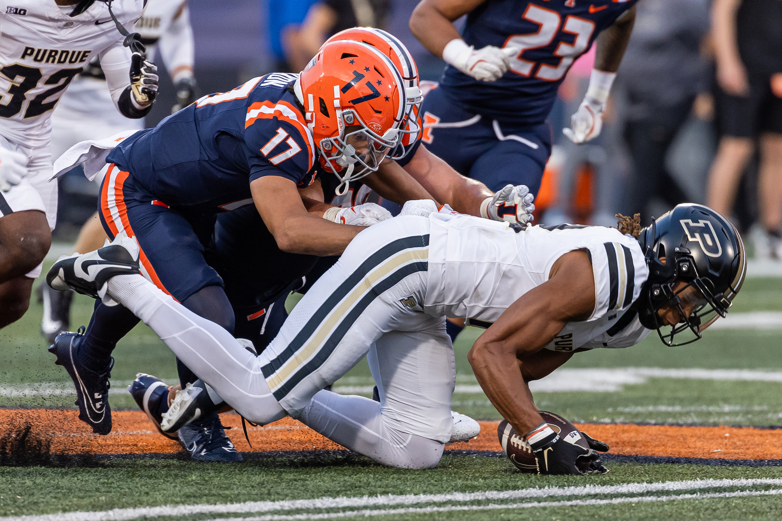 Leland Smith #12 of the Purdue Boilermakers secures an onside kick late in the second half as Collin Dixon #17 of the Illinois Fighting Illini defends at Memorial Stadium on October 12, 2024 in Champaign, Illinois.