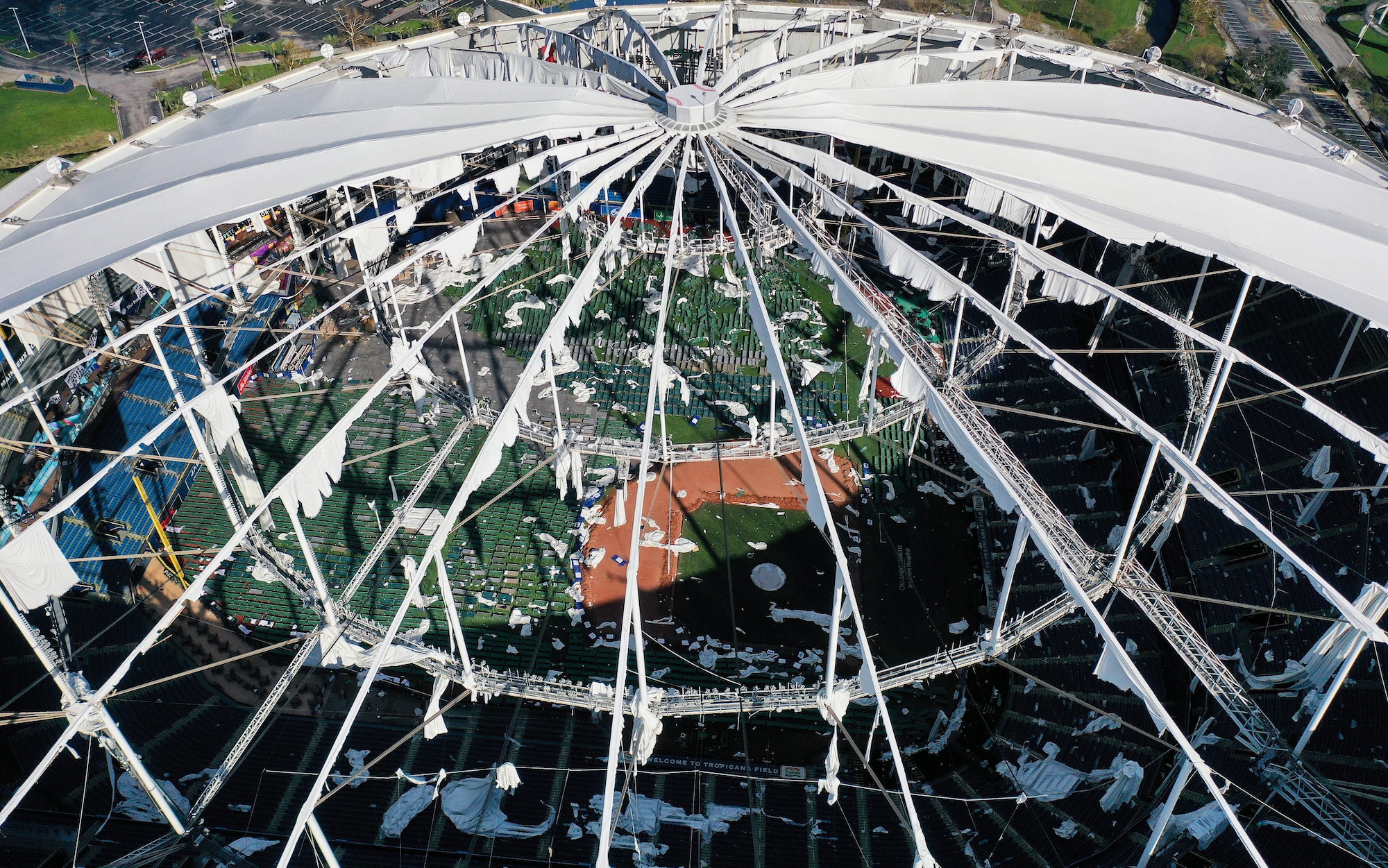 CHIMCHIME, ST PETERSBURG, FLORIDA, UNITED STATES - 2024/10/13: (EDITORS NOTE: Image taken with drone) In this aerial view, the domed roof at Tropicana Field, the home of the Tampa Bay Rays, is seen ripped to shreds from Hurricane Miltonís powerful winds in St. Petersburg. The storm passed through the area on October 10, 2024, making landfall as a Category 3 hurricane in Siesta Key, Florida. (Photo by Paul Hennessy/SOPA Images/LightRocket via Getty Images)