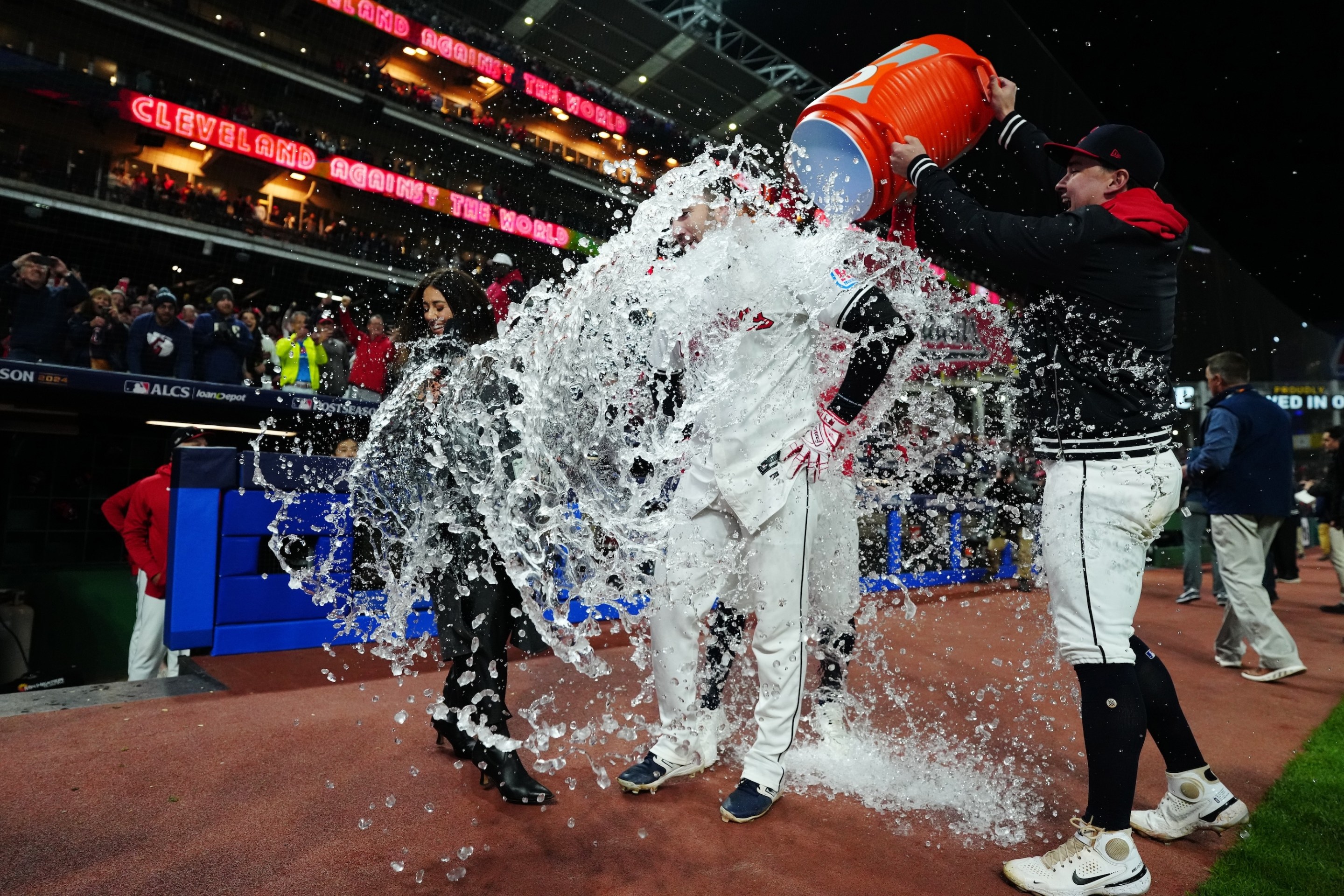 CLEVELAND, OH - OCTOBER 17: David Fry #6 of the Cleveland Guardians gets doused with water after hitting a walk off two-run home run to beat the New York Yankees in Game 3 of the ALCS presented by loanDepot at Progressive Field on Thursday, October 17, 2024 in Cleveland, Ohio. (Photo by Mary DeCicco/MLB Photos via Getty Images)