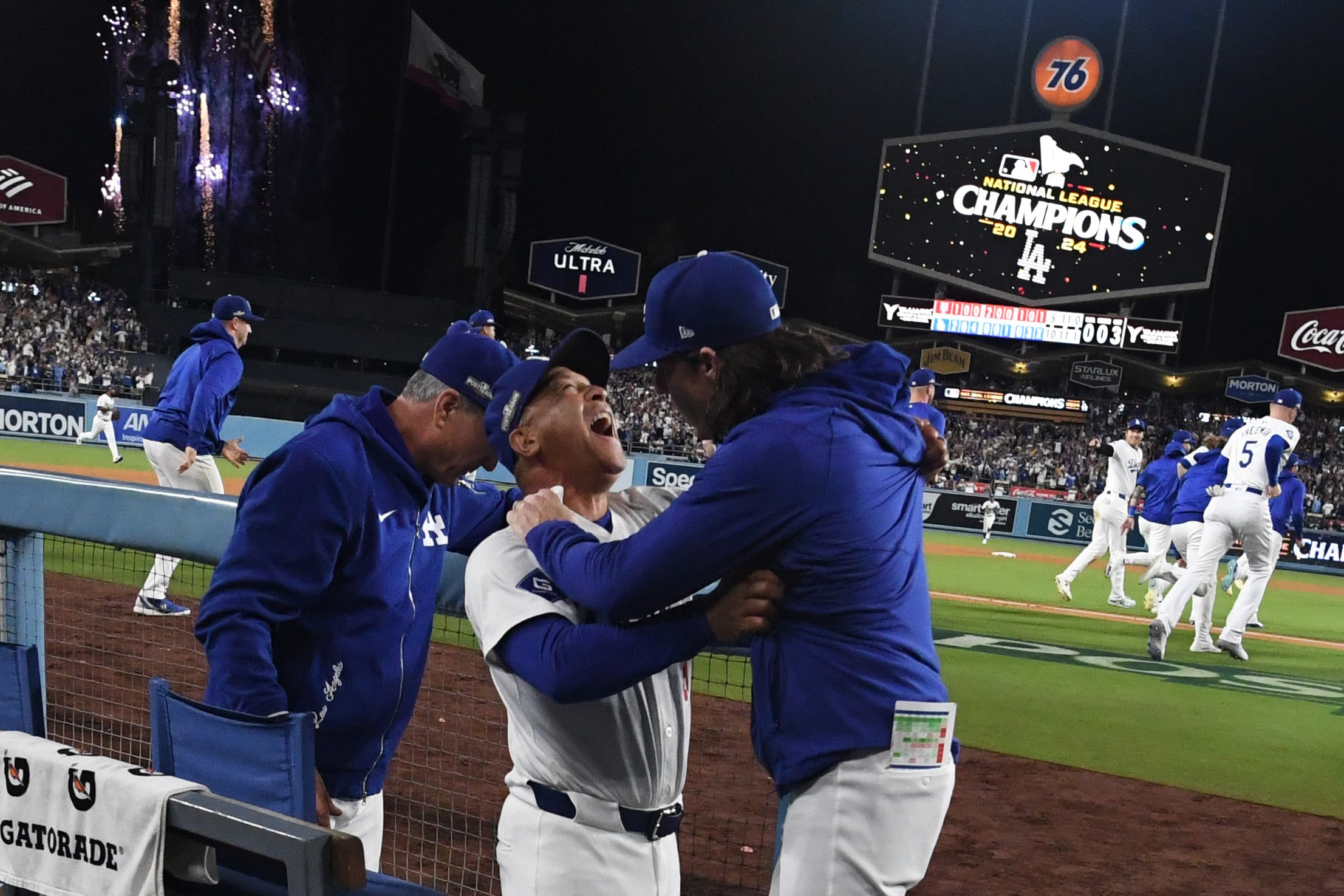 Manager Dave Roberts celebrates with bench coach Danny Lehmann, right, as the Los Angeles Dodgers celebrate after defeating the New York Mets 10-5 to win game 6 of a National League Championship Series at Dodger Stadium in Los Angeles on Sunday, October 20, 2024.