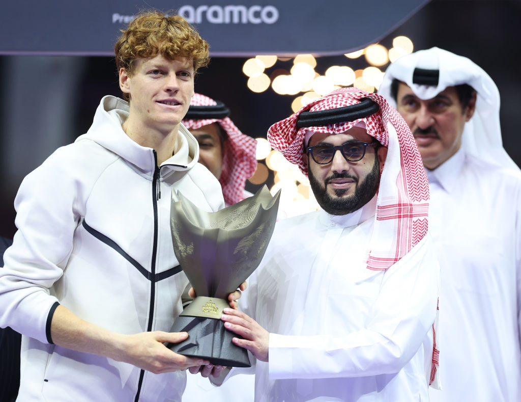 Jannik Sinner of Italy poses for a photo with Turki Alalshikh, Chairman of the General Entertainment Authority, after being awarded the trophy following victory in his Men's Singles Final match against Carlos Alcaraz of Spain