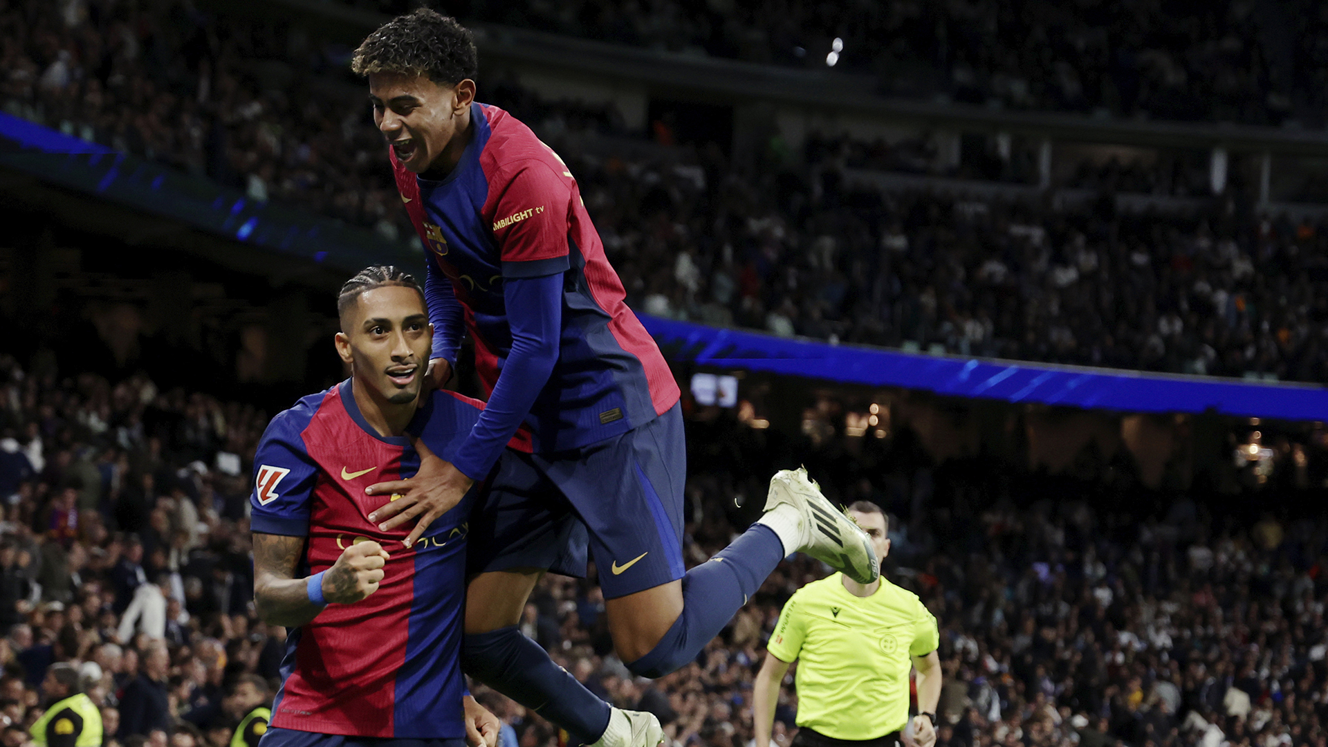 Raphinha of FC Barcelona celebrates 0-4 with Lamine Yamal of FC Barcelona during the LaLiga EA Sports match between Real Madrid v FC Barcelona at the Estadio Santiago Bernabeu on October 26, 2024 in Madrid Spain