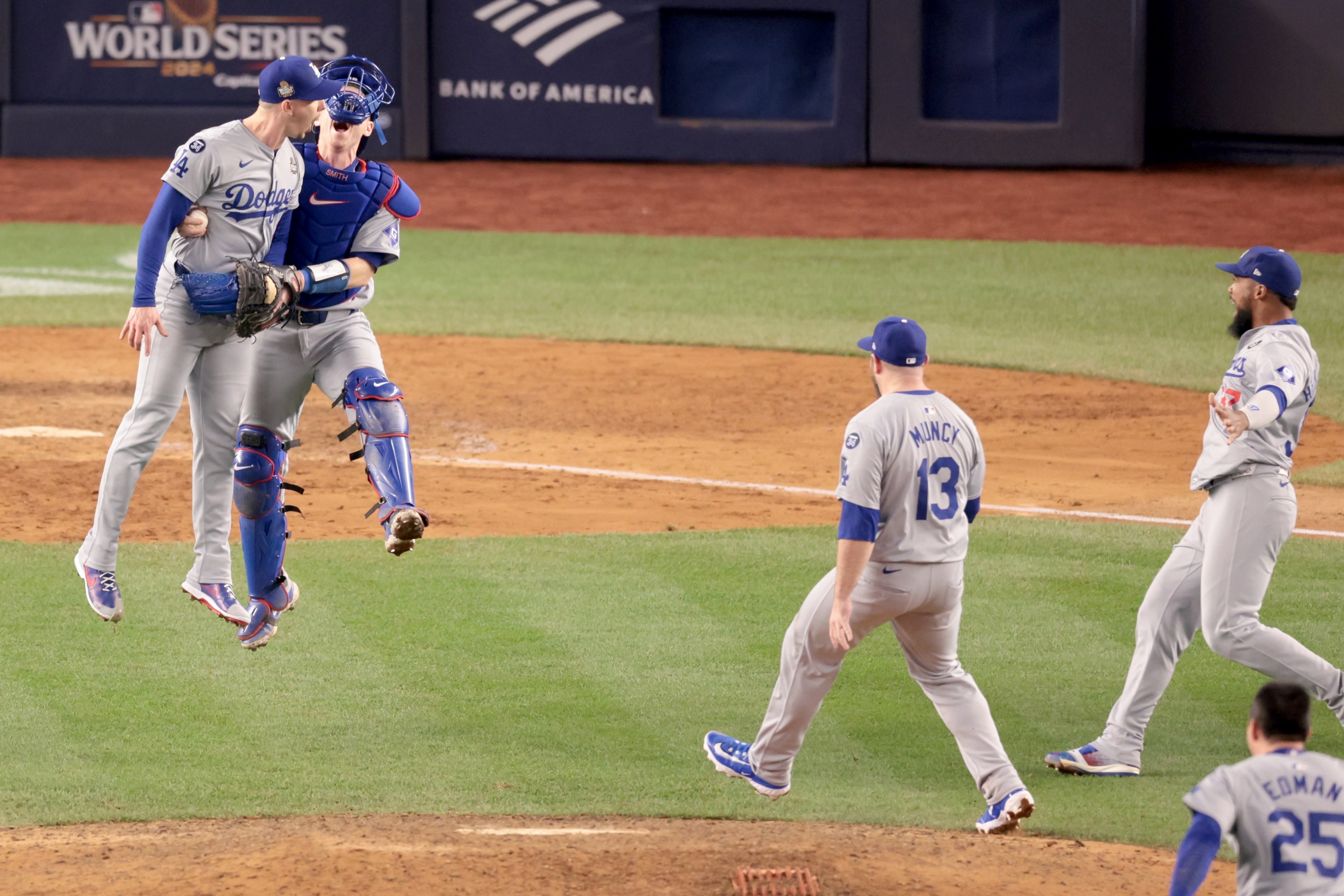 Teammates celebrate with "Los Angeles Dodgers pitcher Walker Buehler (21), left, after winning the World Series. Game 5 of the World Series against the Yankees at Yankees Stadium in New York City Wednesday, October 30, 2024.