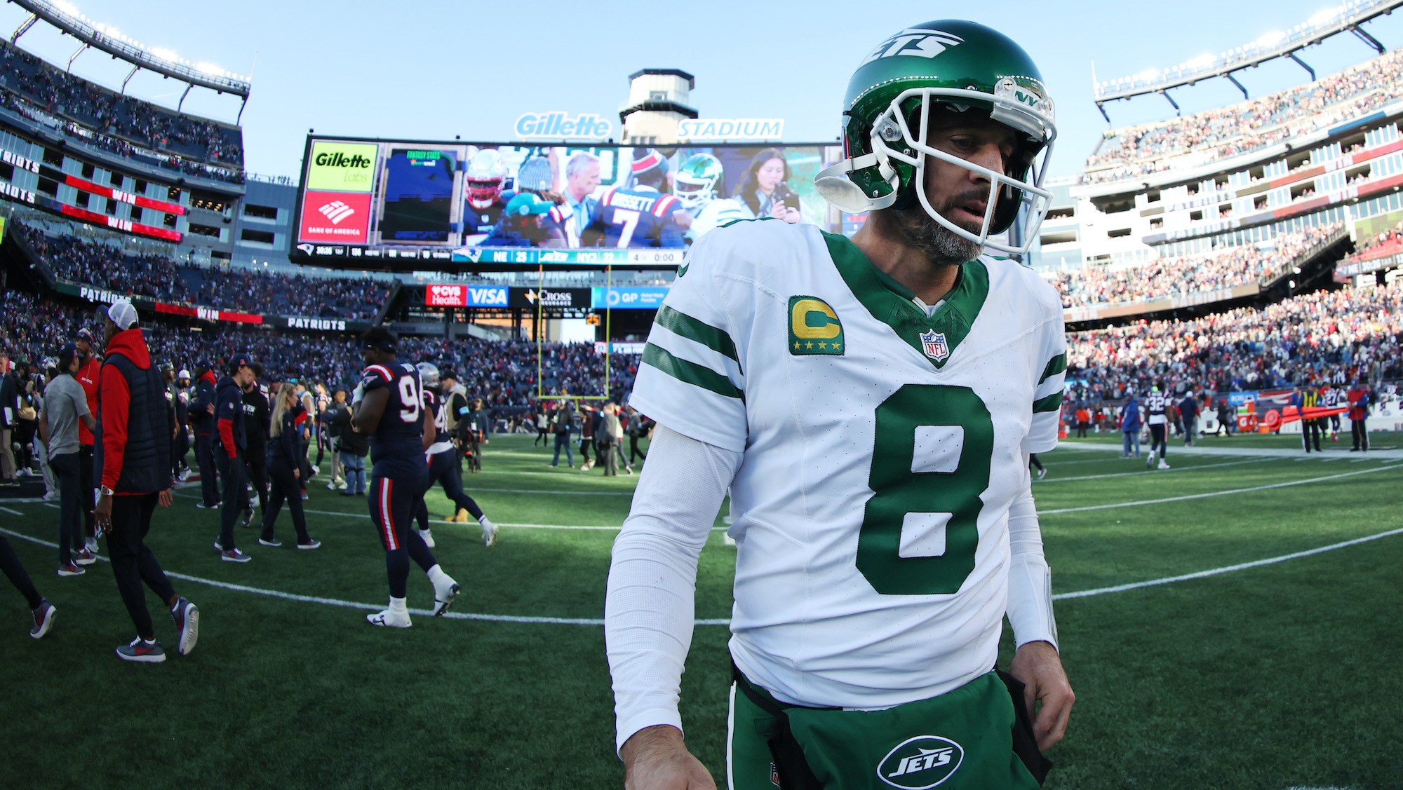 Aaron Rodgers #8 of the New York Jets walks off the field after the game against the New England Patriots