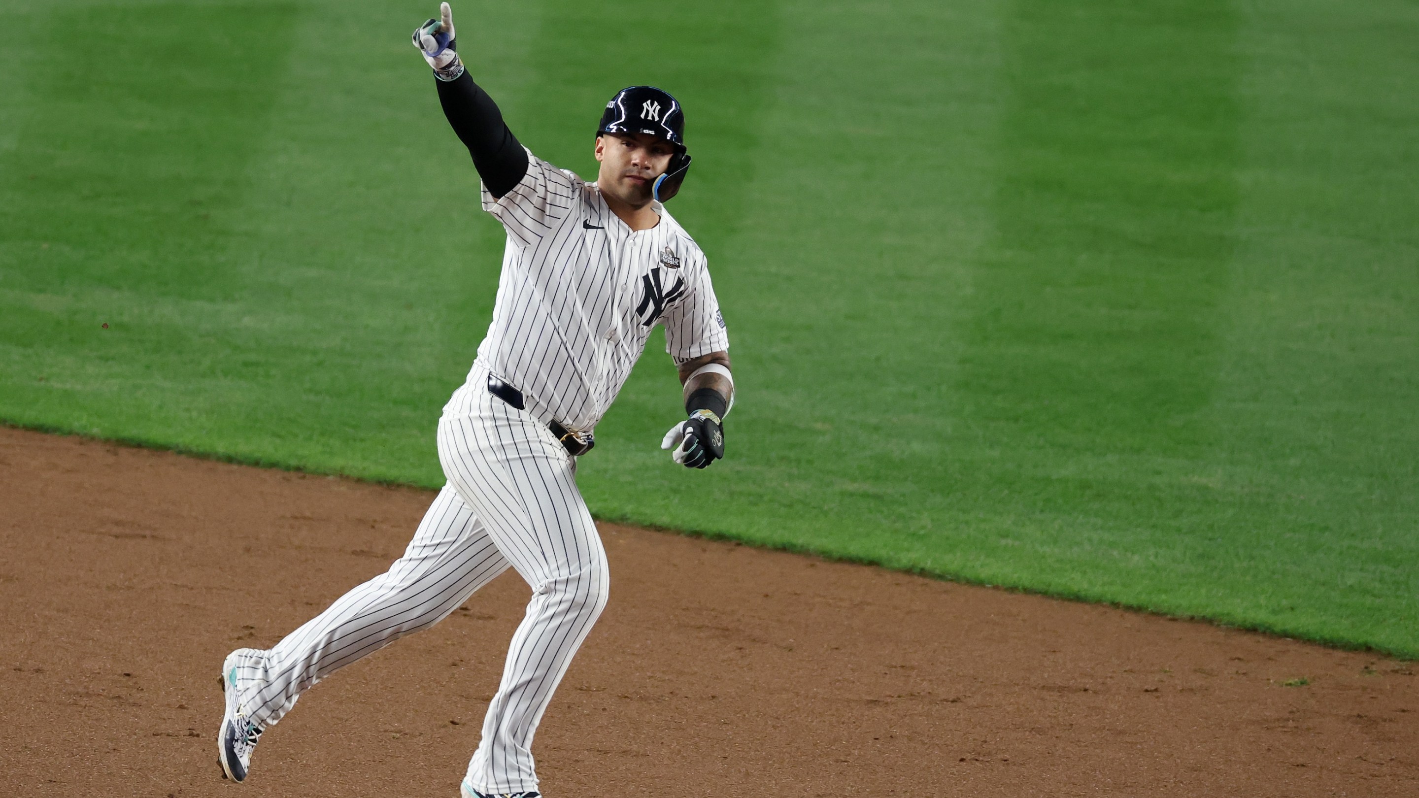 Gleyber Torres of the Yankees celebrates his eighth-inning homer in Game 4 of the 2024 World Series while rounding the baes at Yankee Stadium.