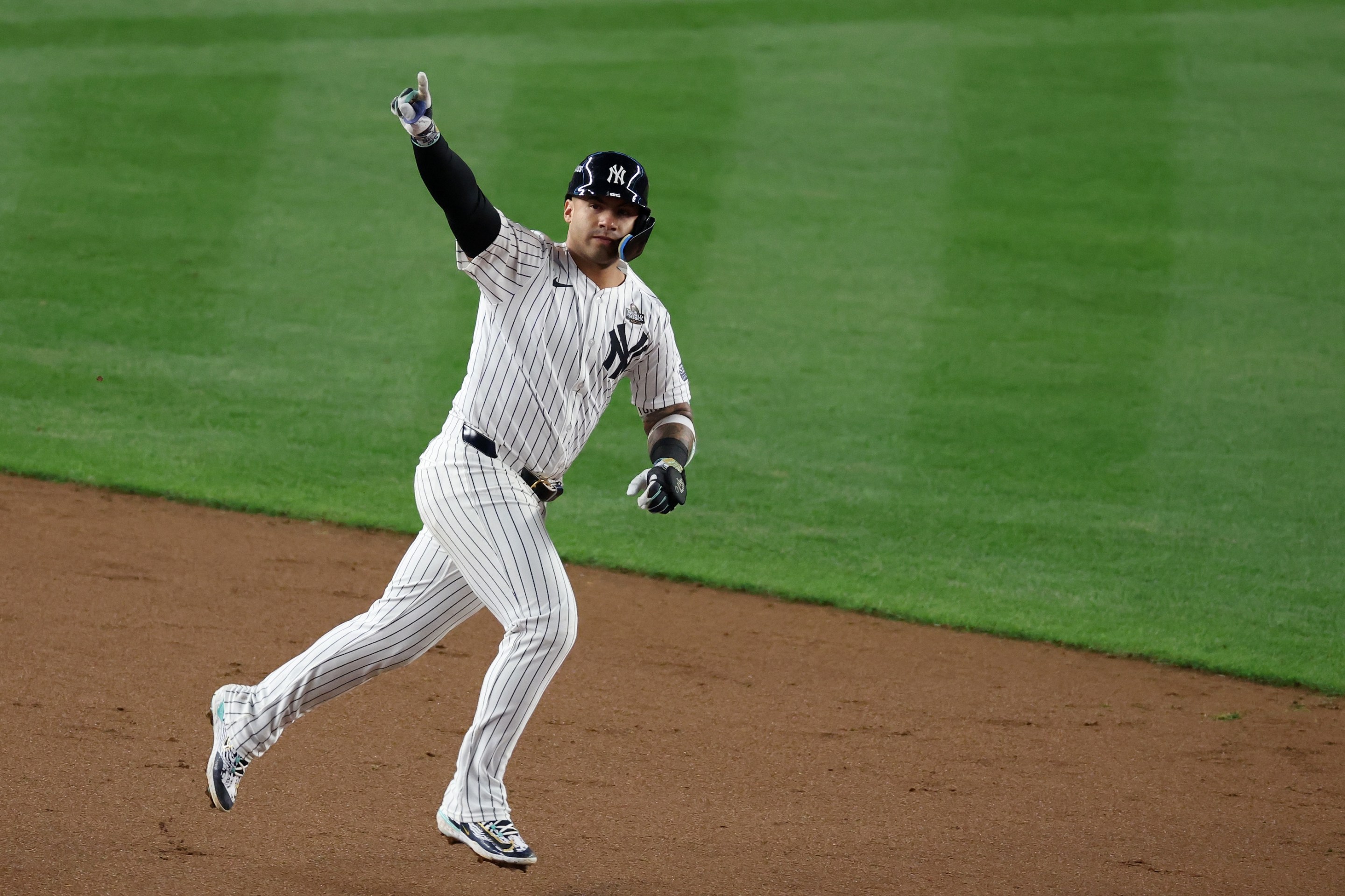 Gleyber Torres of the Yankees celebrates his eighth-inning homer in Game 4 of the 2024 World Series while rounding the baes at Yankee Stadium.