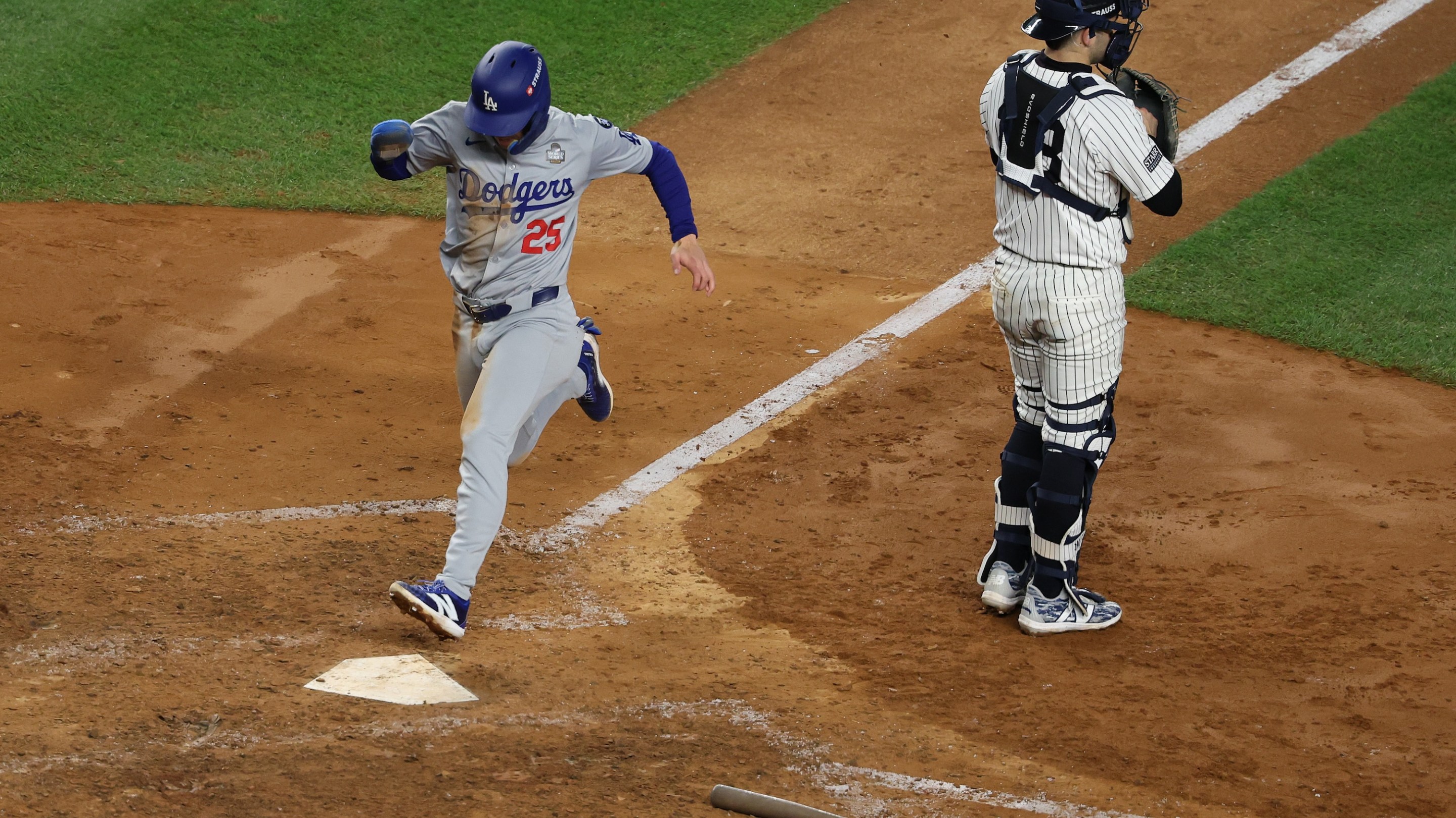 NEW YORK, NEW YORK - OCTOBER 30: Tommy Edman #25 of the Los Angeles Dodgers scores the go-ahead run on a sacrifice fly by Mookie Betts #50 during the eighth inning of Game Five of the 2024 World Series against the New York Yankees at Yankee Stadium on October 30, 2024 in the Bronx borough of New York City. (Photo by Al Bello/Getty Images)