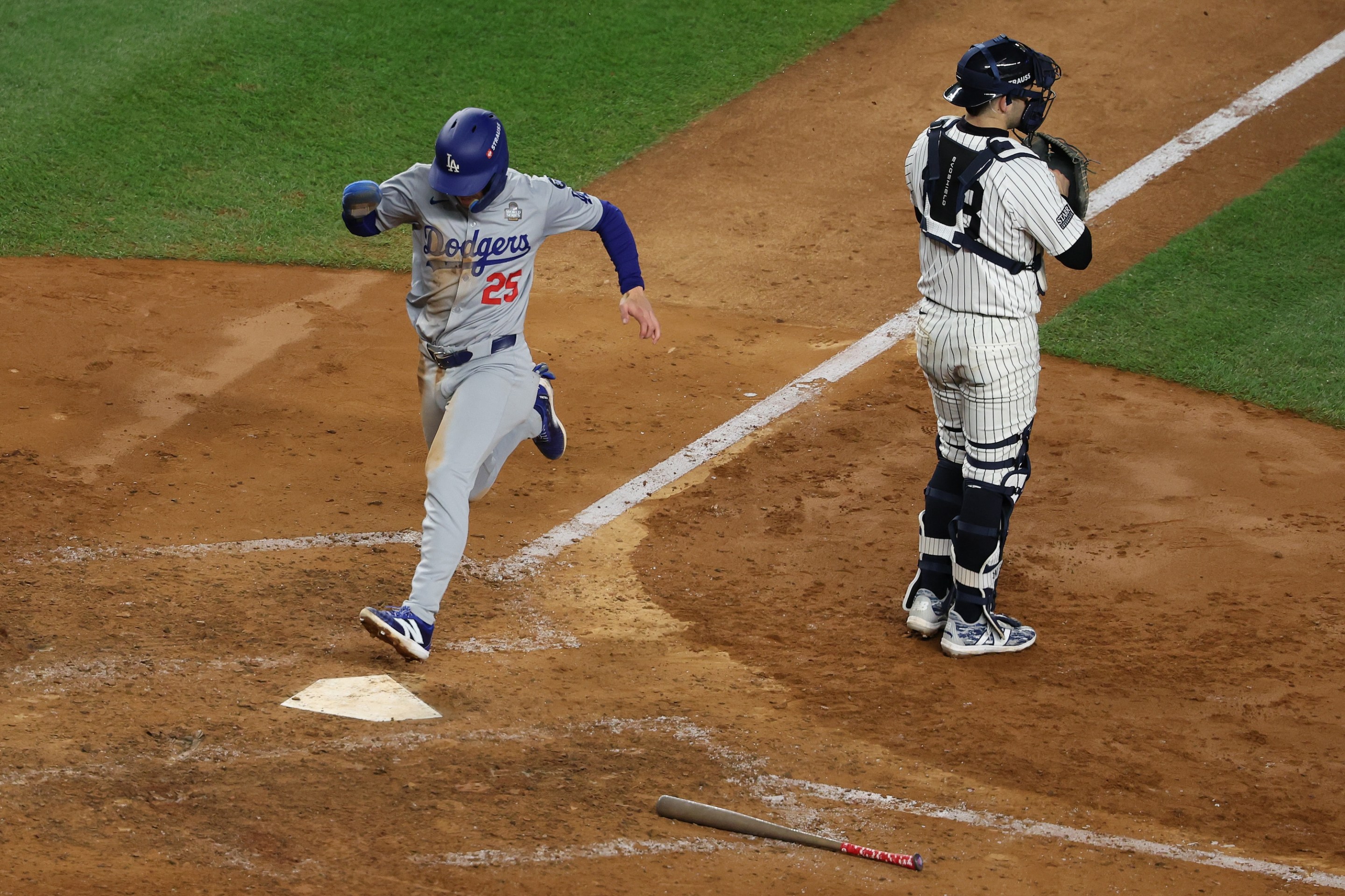 NEW YORK, NEW YORK - OCTOBER 30: Tommy Edman #25 of the Los Angeles Dodgers scores the go-ahead run on a sacrifice fly by Mookie Betts #50 during the eighth inning of Game Five of the 2024 World Series against the New York Yankees at Yankee Stadium on October 30, 2024 in the Bronx borough of New York City. (Photo by Al Bello/Getty Images)