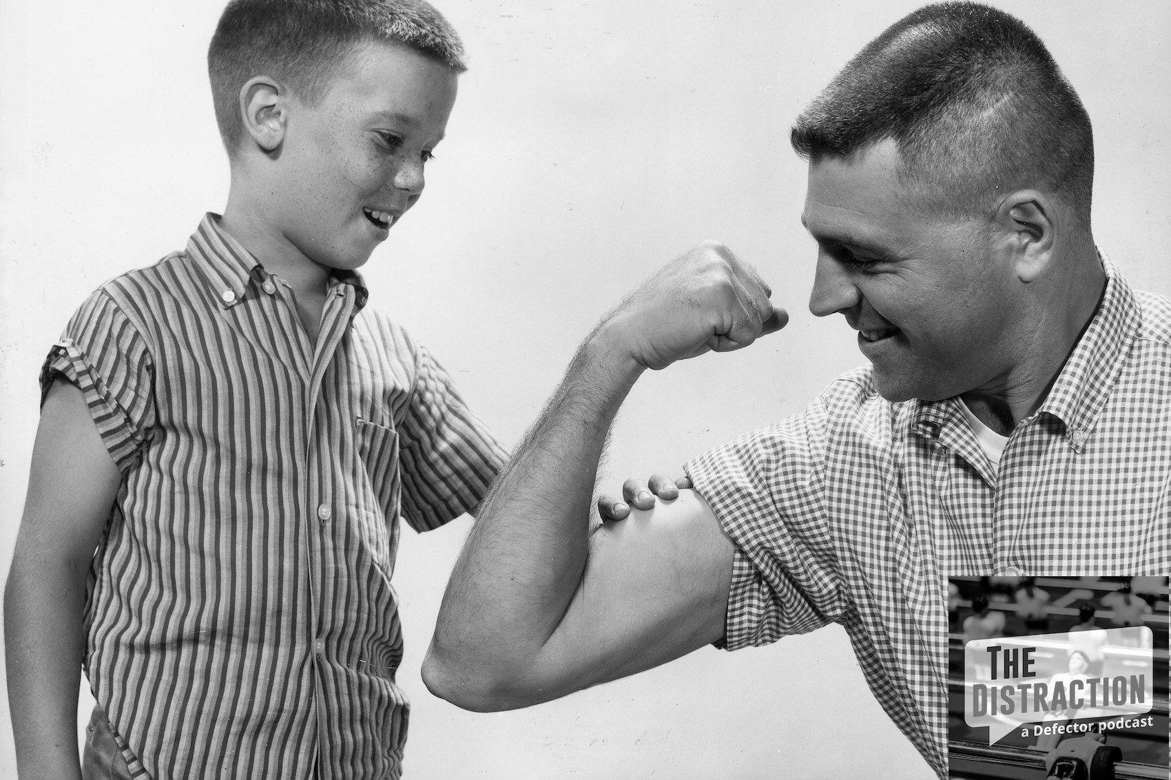 circa 1955: Studio image of a father flexing his bicep for his young freckle-faced son to feel, 1950s. (Photo by Harold M. Lambert/Lambert/Getty Images)