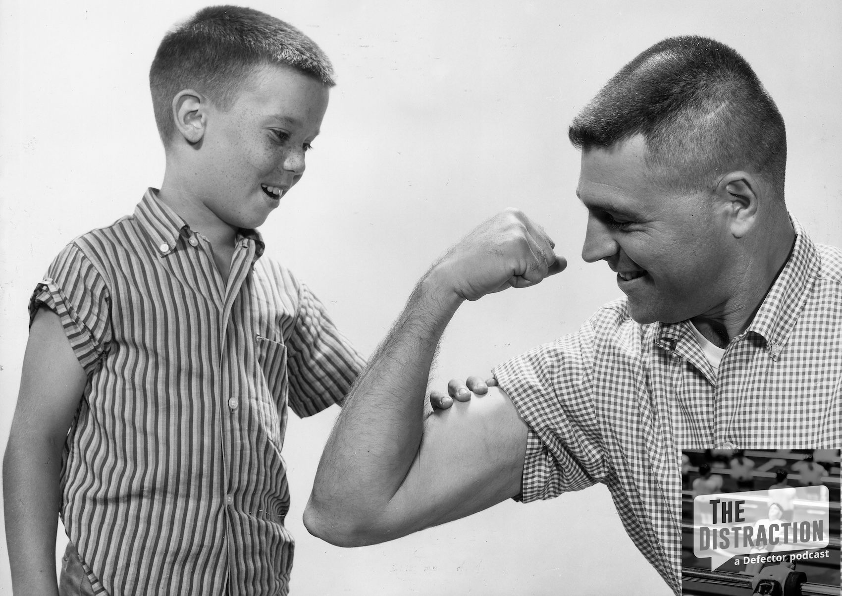 circa 1955: Studio image of a father flexing his bicep for his young freckle-faced son to feel, 1950s. (Photo by Harold M. Lambert/Lambert/Getty Images)