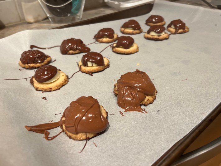 Tempered chocolate sort of clumped up on top of the biscuits and fondant.