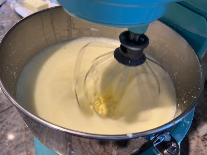 Crème Anglaise is whisked in a stand mixer.