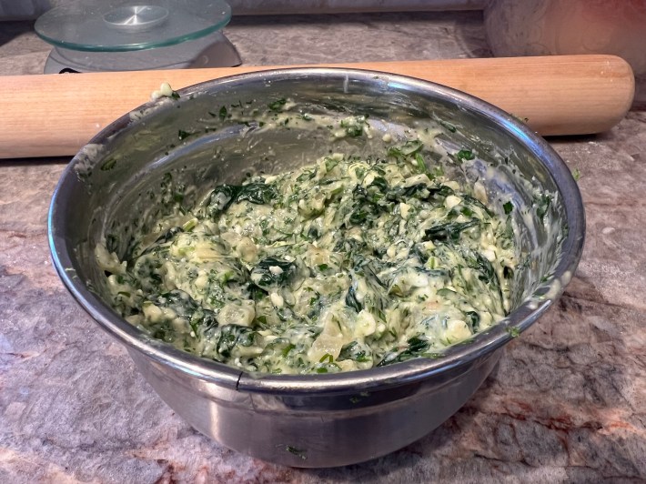 A bowl of spanakopita filling.