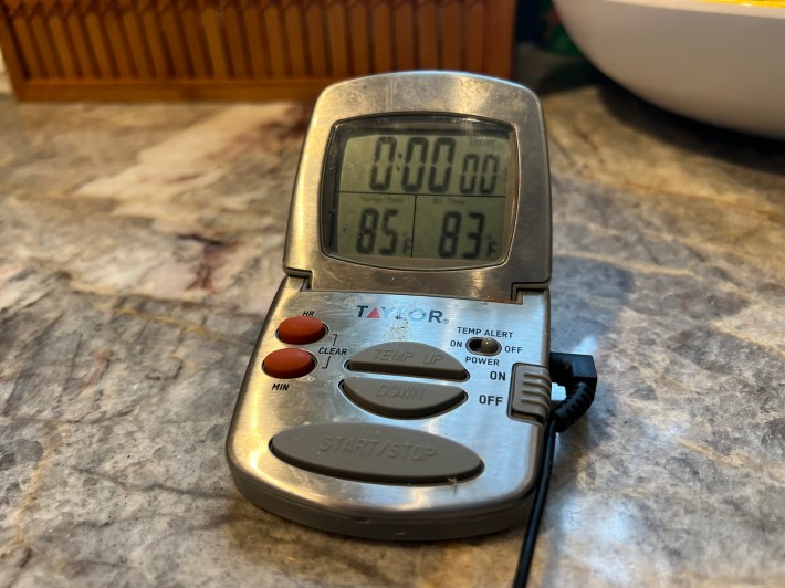 A digital meat thermometer showing a temperature of 85 degrees F.