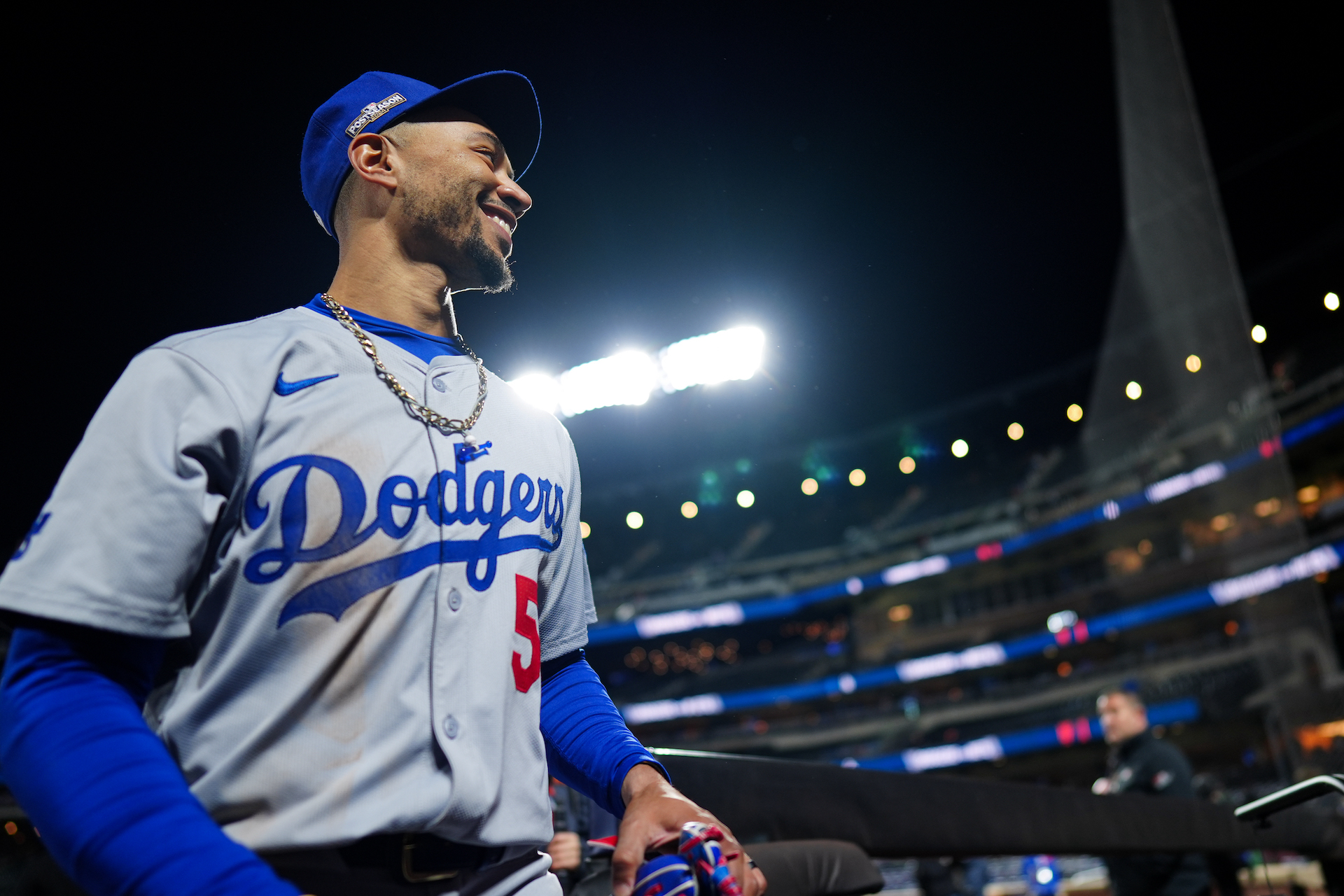 Mookie Betts #50 of the Los Angeles Dodgers returns to the dugout after winning Game 4 of the NLCS.