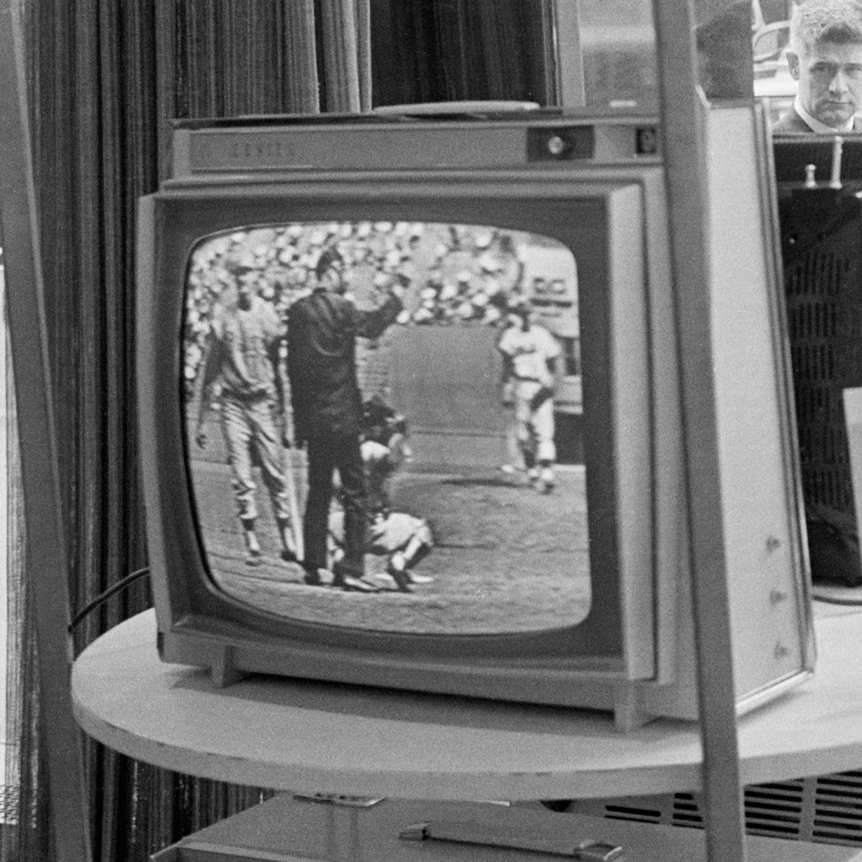 Businessmen stop and watch a televised Phillies Mets game on a Zenith TV on May 08, 1963.