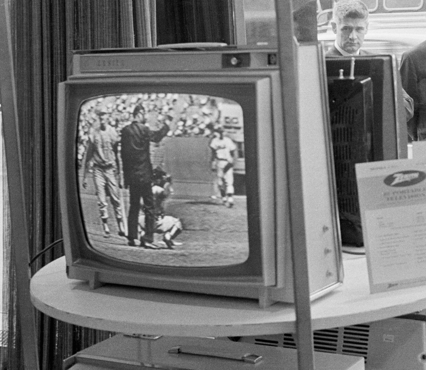 Businessmen stop and watch a televised Phillies Mets game on a Zenith TV on May 08, 1963.