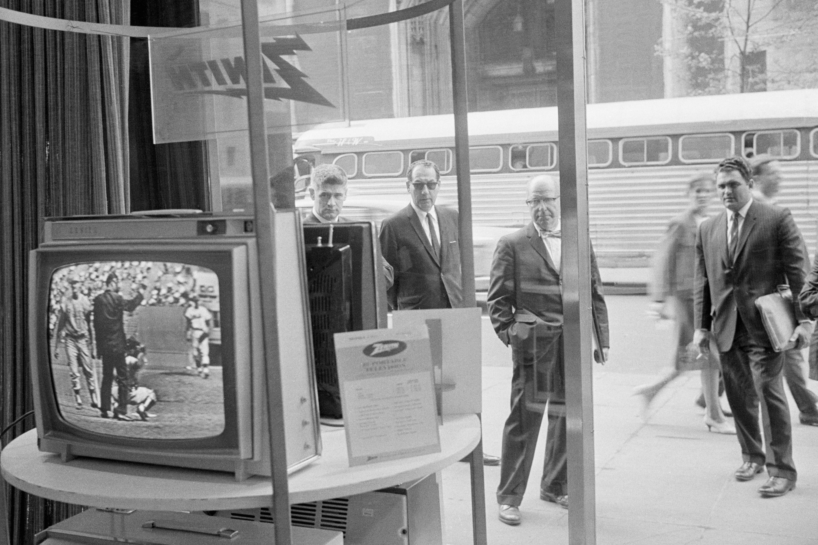 Businessmen stop and watch a televised Phillies Mets game on a Zenith TV on May 08, 1963.