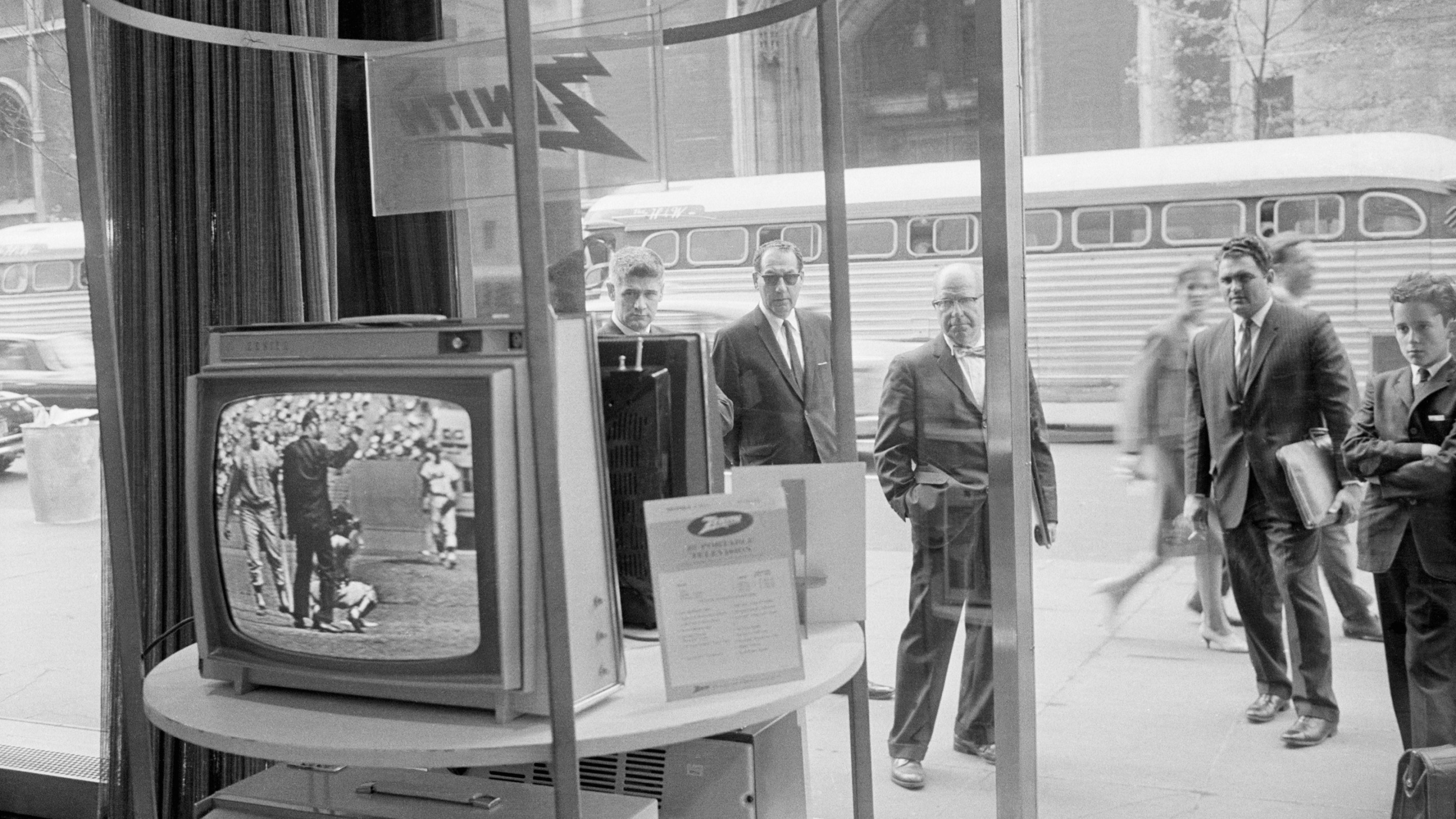 Businessmen stop and watch a televised Phillies Mets game on a Zenith TV on May 08, 1963.