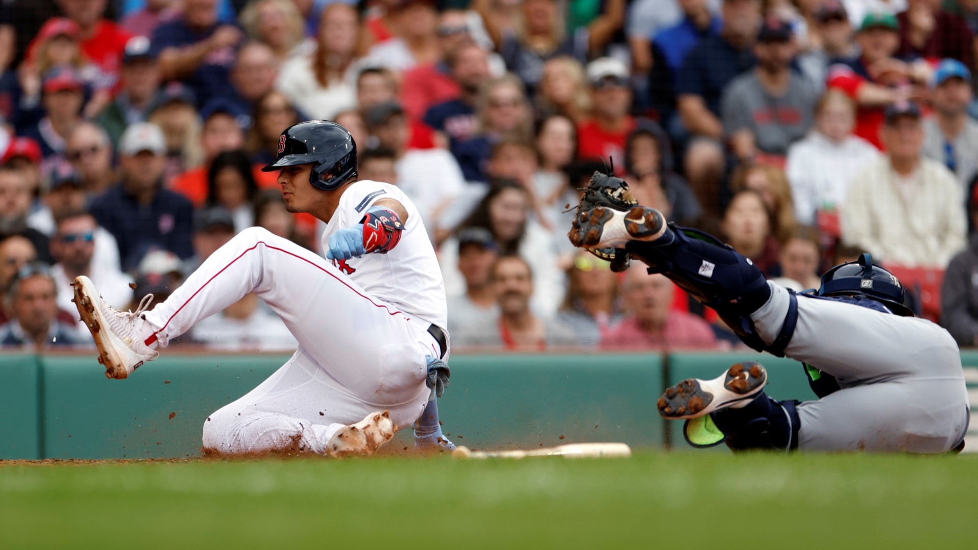 Boston Red Sox 2B Vaughn Grissom slides to home plate past the tag by Tampa Bay Rays C Logan Driscoll in the third inning.