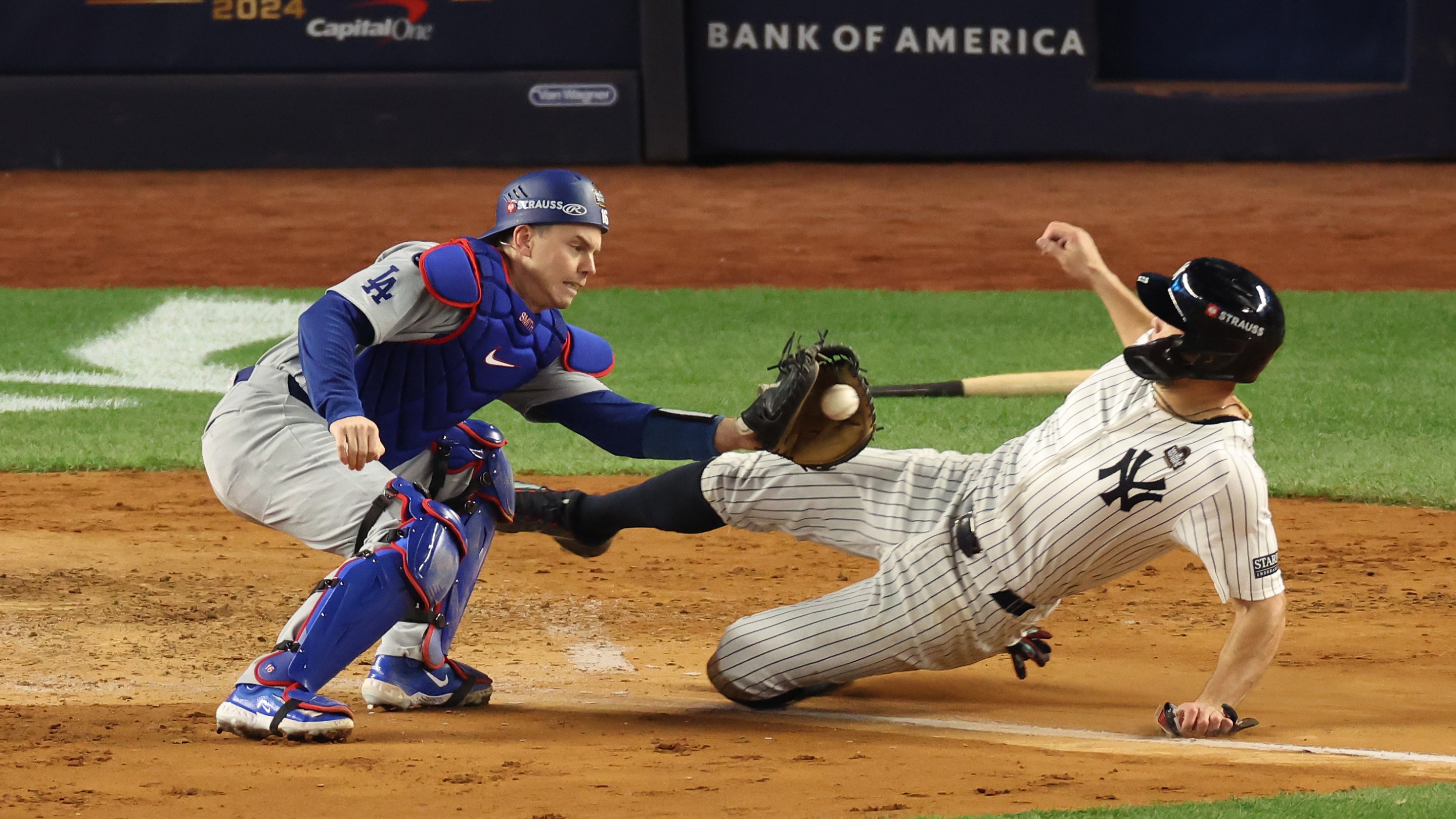 Will Smith #16 of the Los Angeles Dodgers tags out Giancarlo Stanton #27 of the New York Yankees at home plate.