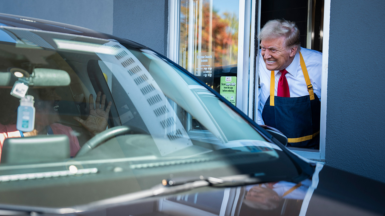 Feasterville-Trevose, PA - October 20 : Republican presidential nominee former President Donald Trump hands out food while standing at a drive-thru window during a campaign stop at a McDonald's in Feasterville-Trevose, PA on Sunday, Oct. 20, 2024.