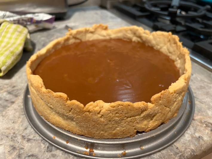 A pie crust filled with liquid caramel.