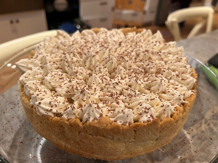 A completed Banoffee Pie, with piped Chantilly cream and grated chocolate.