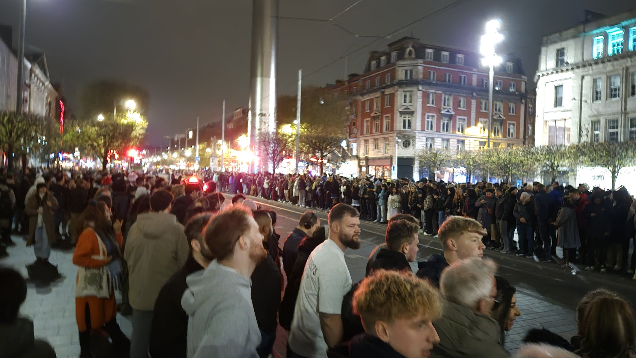 Dubliners line the sidewalks waiting for a Halloween parade that will never begin.