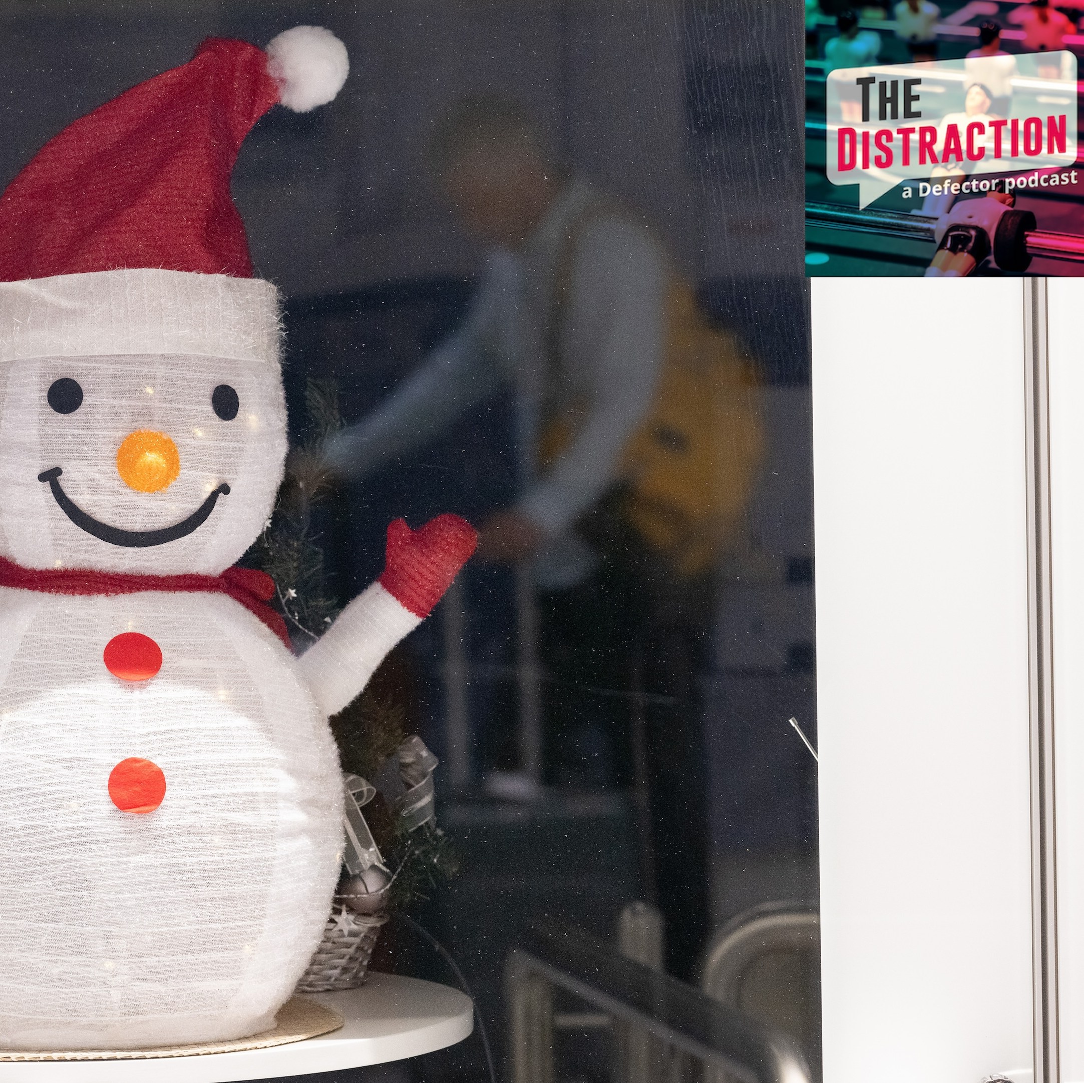 A traveler is reflected in a pane of glass with a paper snowman behind it during travel on Christmas Day at Frankfurt Airport.