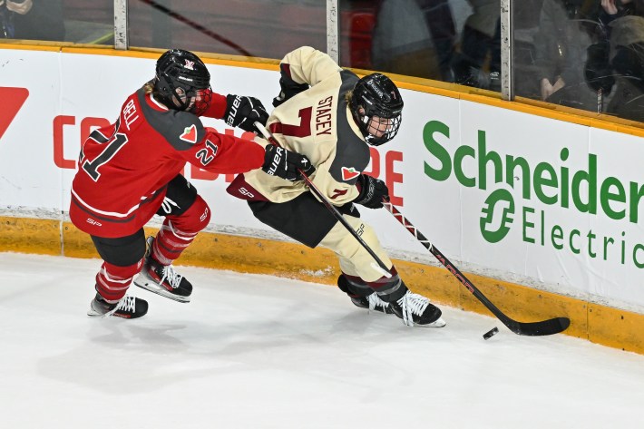 OTTAWA, CANADA - JANUARY 02: Laura Stacey #7 of Montreal skates the puck against Ashton Bell #21 of Ottawa during the third period in the Professional Women's Hockey League (PWHL) game at The Arena at TD Place on January 2, 2024 in Ottawa, Ontario, Canada. Montreal defeated Ottawa 3-2 in overtime.