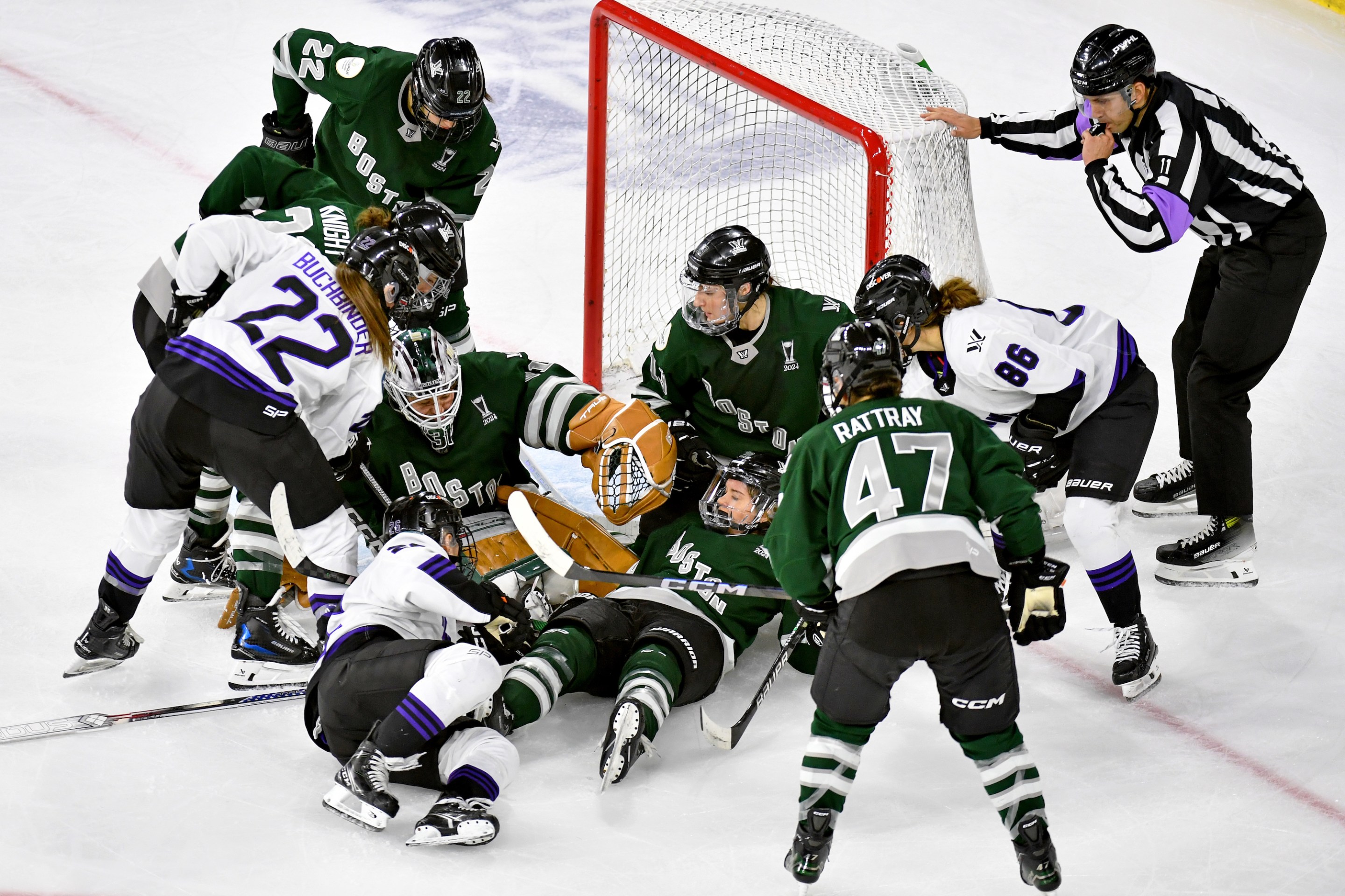 Referee David Elford blows the whistle as he loses sight of the puck somewhere under Kaleigh Fratkin #13, Hannah Brandt #20, Aerin Frankel #31 of Boston in the crease during scrum in the second period at Tsongas Center on May 29, 2024 in Lowell, Massachusetts.