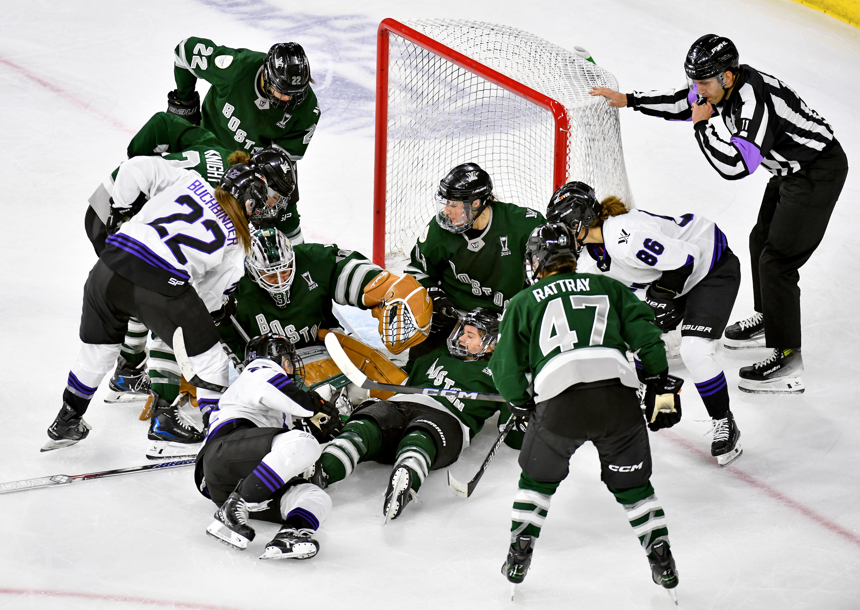 Referee David Elford blows the whistle as he loses sight of the puck somewhere under Kaleigh Fratkin #13, Hannah Brandt #20, Aerin Frankel #31 of Boston in the crease during scrum in the second period at Tsongas Center on May 29, 2024 in Lowell, Massachusetts.