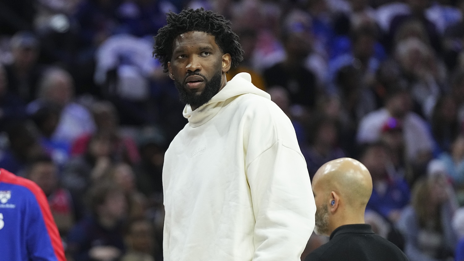 PHILADELPHIA, PENNSYLVANIA - OCTOBER 23: Joel Embiid #21 of the Philadelphia 76ers looks on during a timeout against the Milwaukee Bucks in the first half at the Wells Fargo Center on October 23, 2024 in Philadelphia, Pennsylvania.