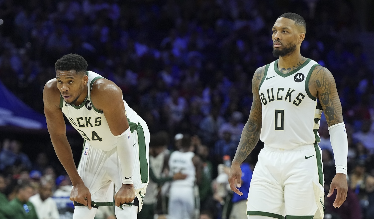 PHILADELPHIA, PENNSYLVANIA - OCTOBER 23: Giannis Antetokounmpo #34 and Damian Lillard #0 of the Milwaukee Bucks look on against the Philadelphia 76ers at the Wells Fargo Center on October 23, 2024 in Philadelphia, Pennsylvania. The Bucks defeated the 76ers 124-109. (Photo by Mitchell Leff/Getty Images)